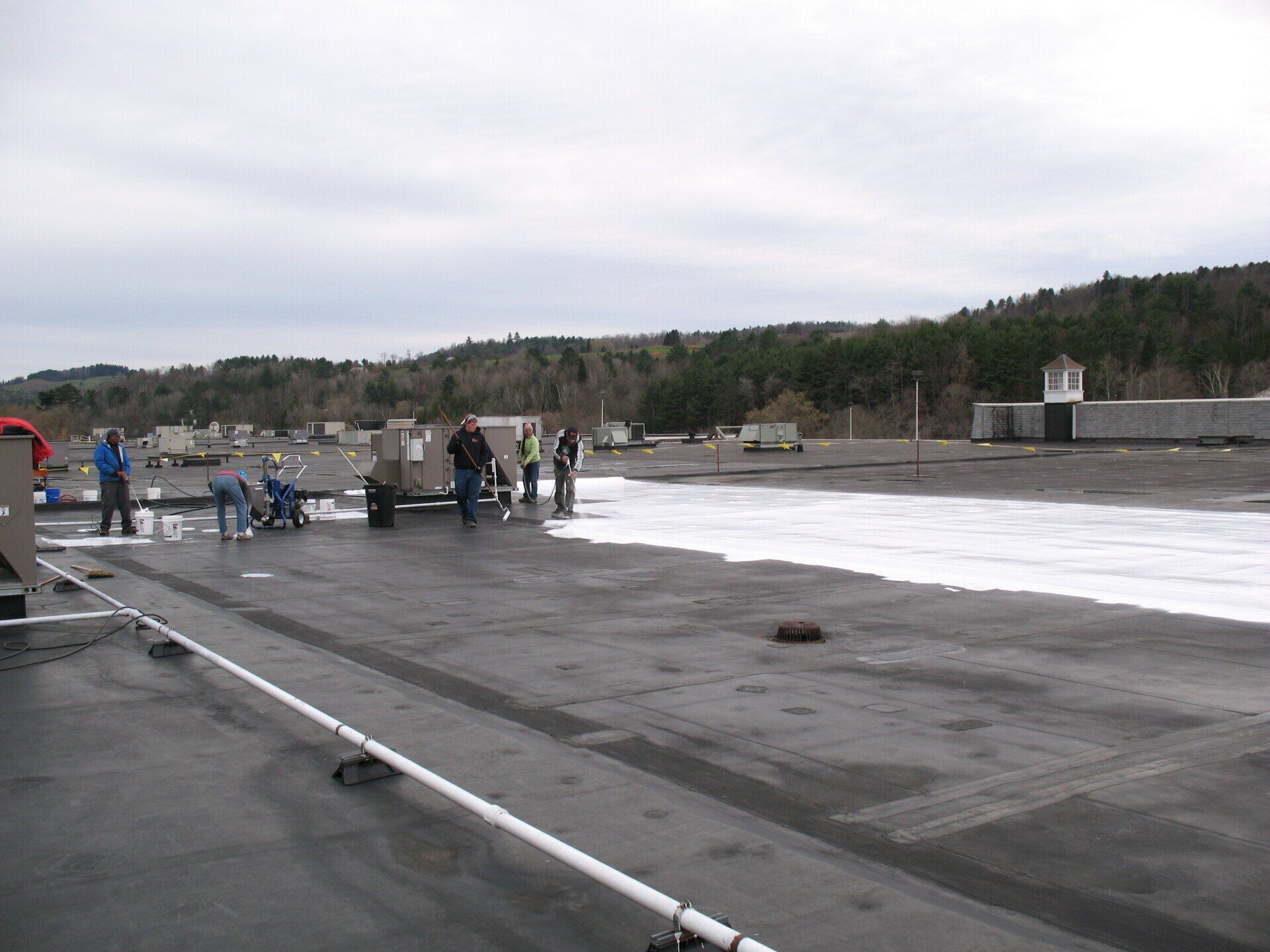 A group of people are working on the roof of a building
