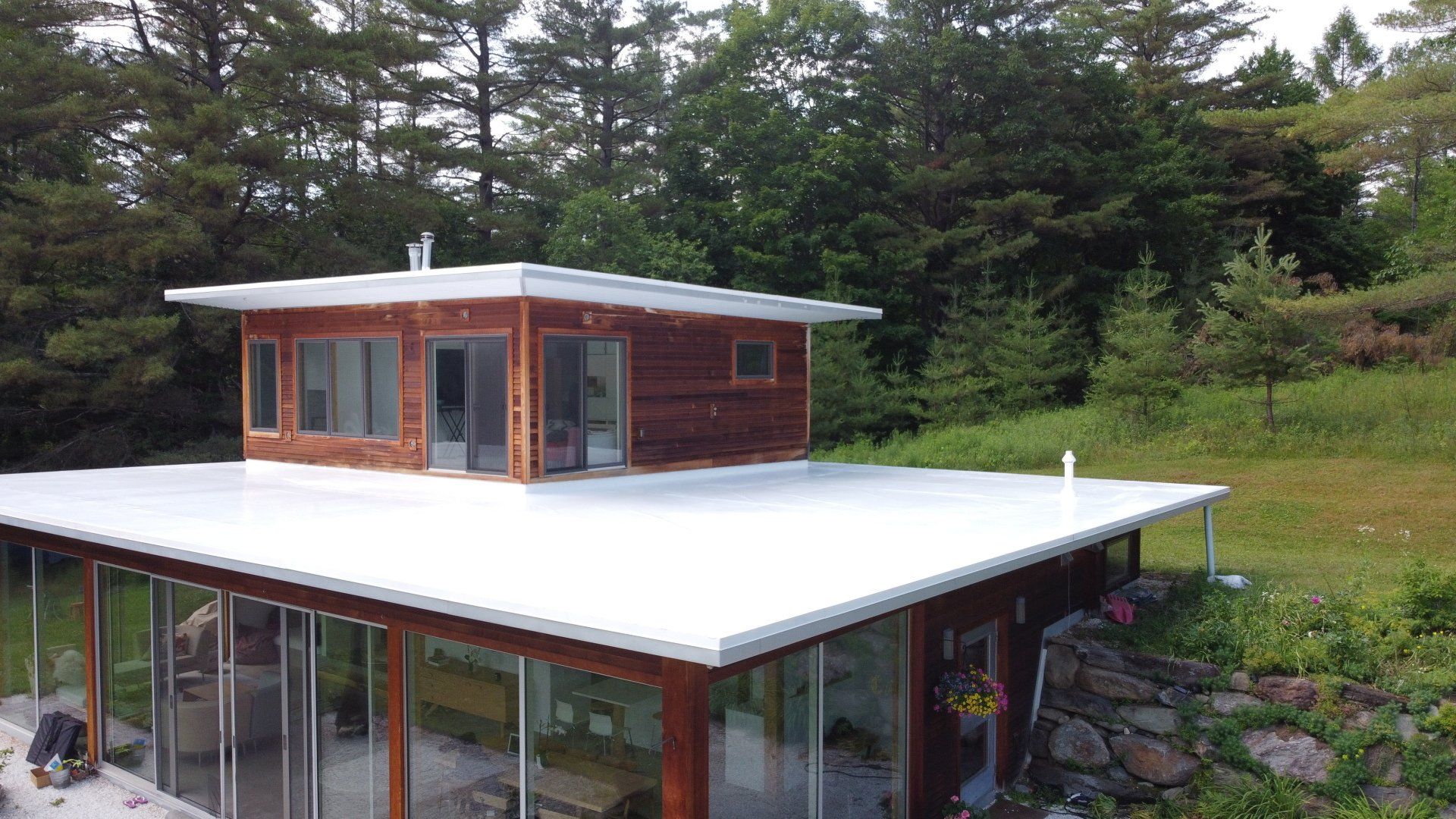 Red house with white single-ply roofing system in Vermont