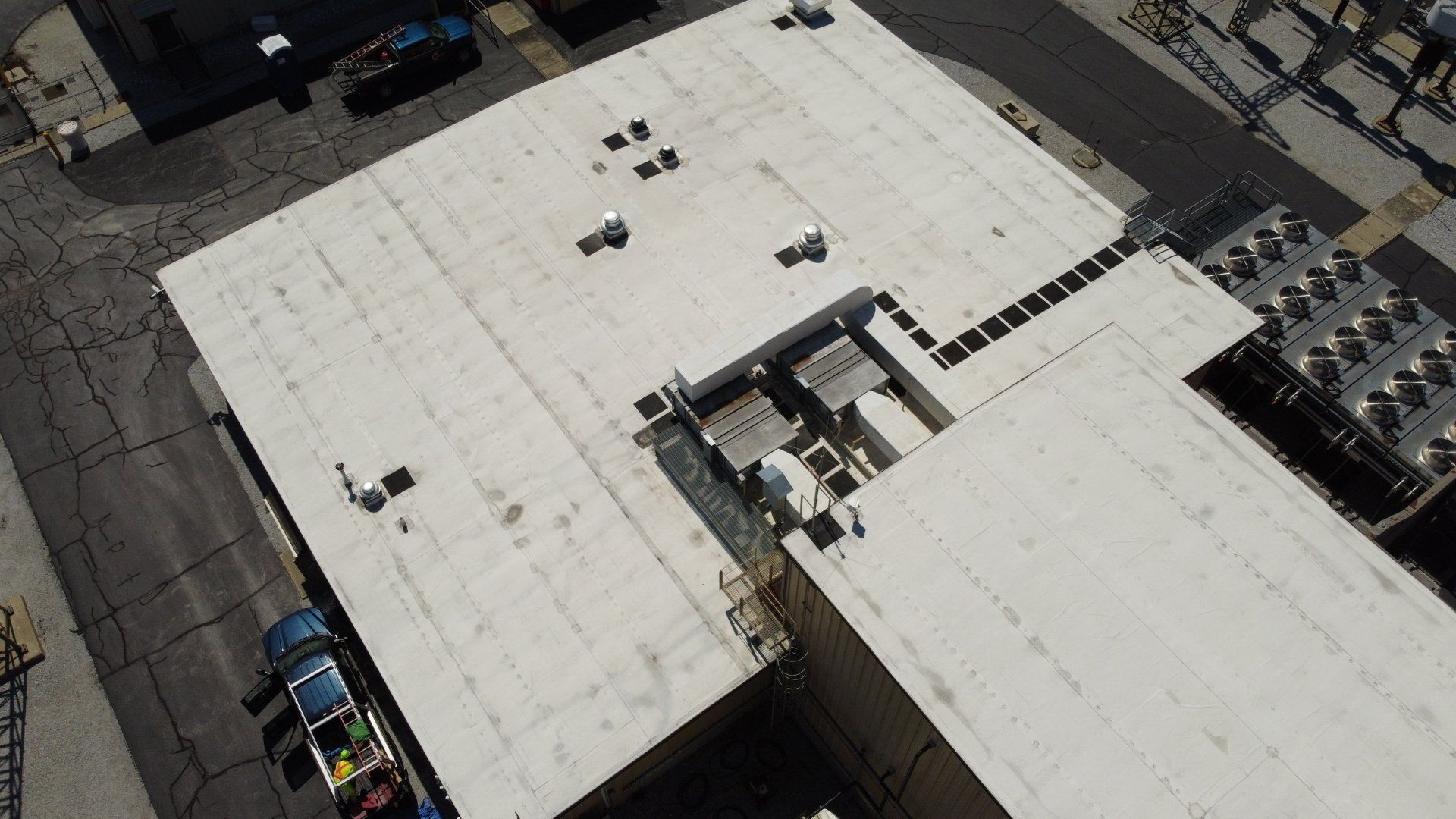 An aerial view of a white roof of a building.