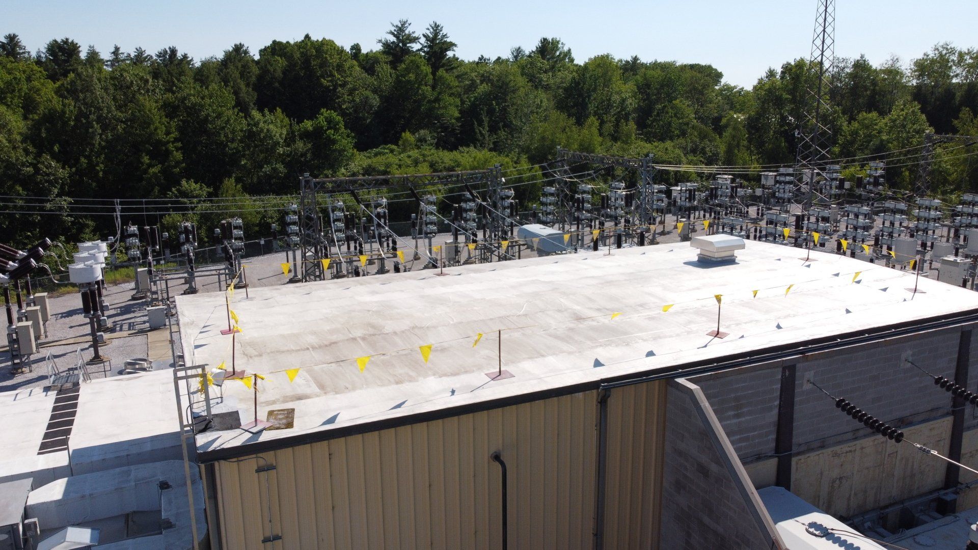 An aerial view of a roof of a building with trees in the background.