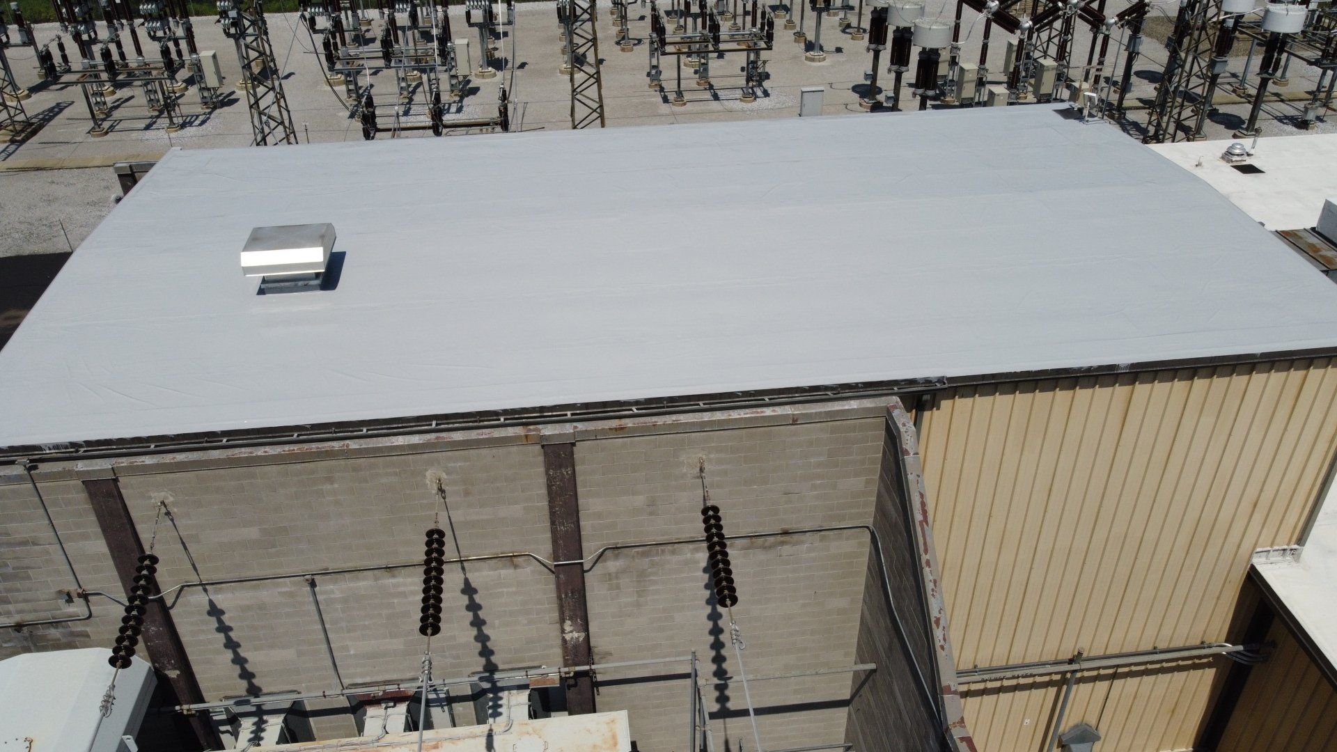 An aerial view of a building with a white roof.