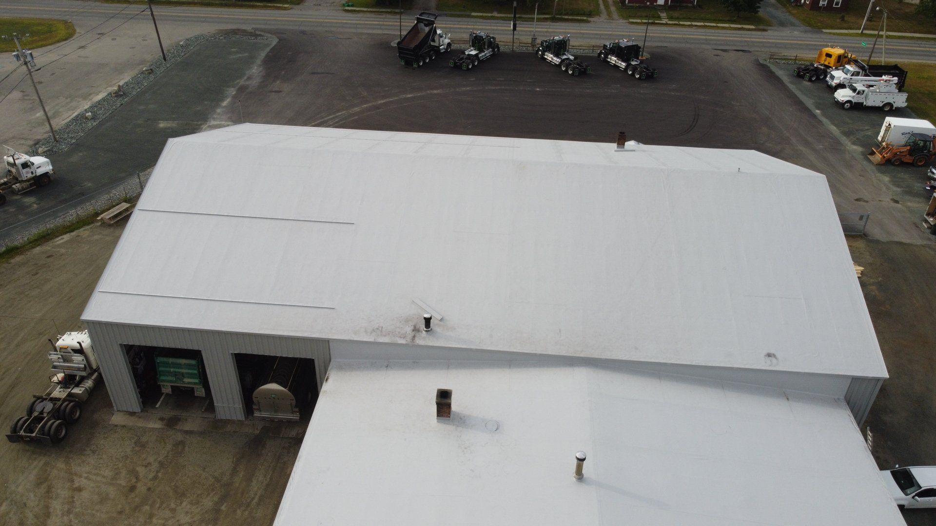 Aerial view, Rodd Roofing metal retrofit completion, machinery around.