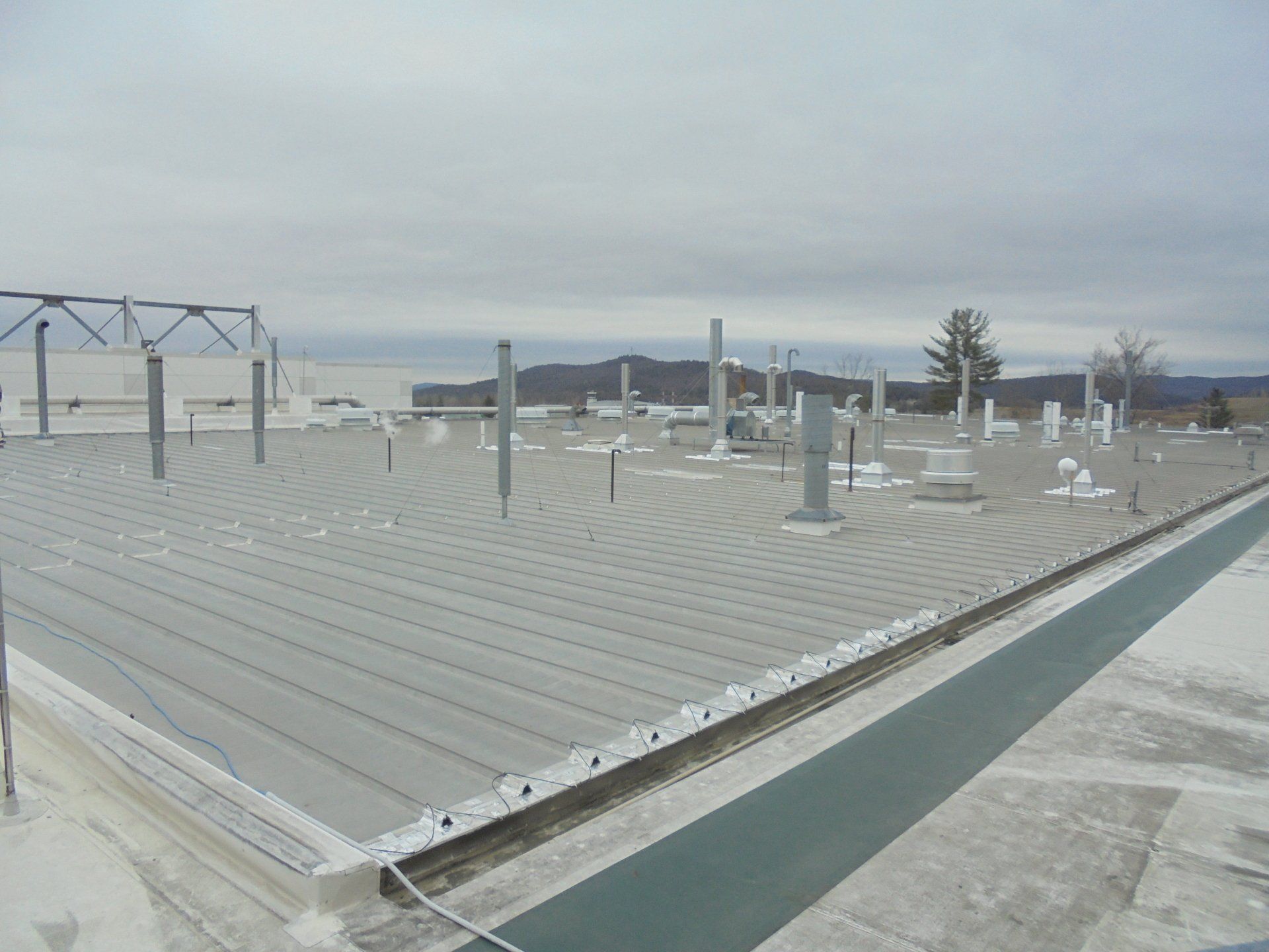 A large roof with a lot of pipes on it