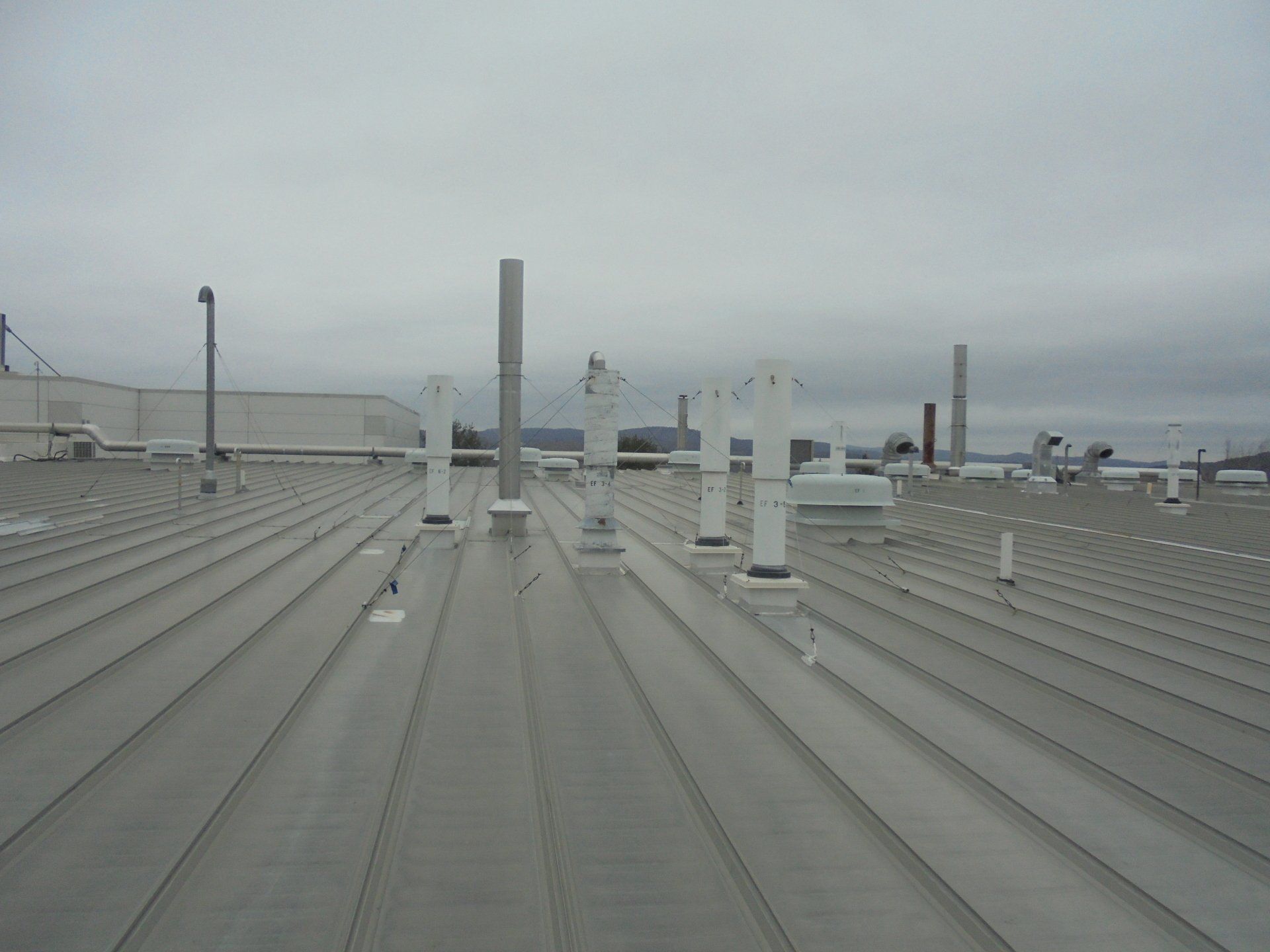 A roof with a lot of chimneys on it