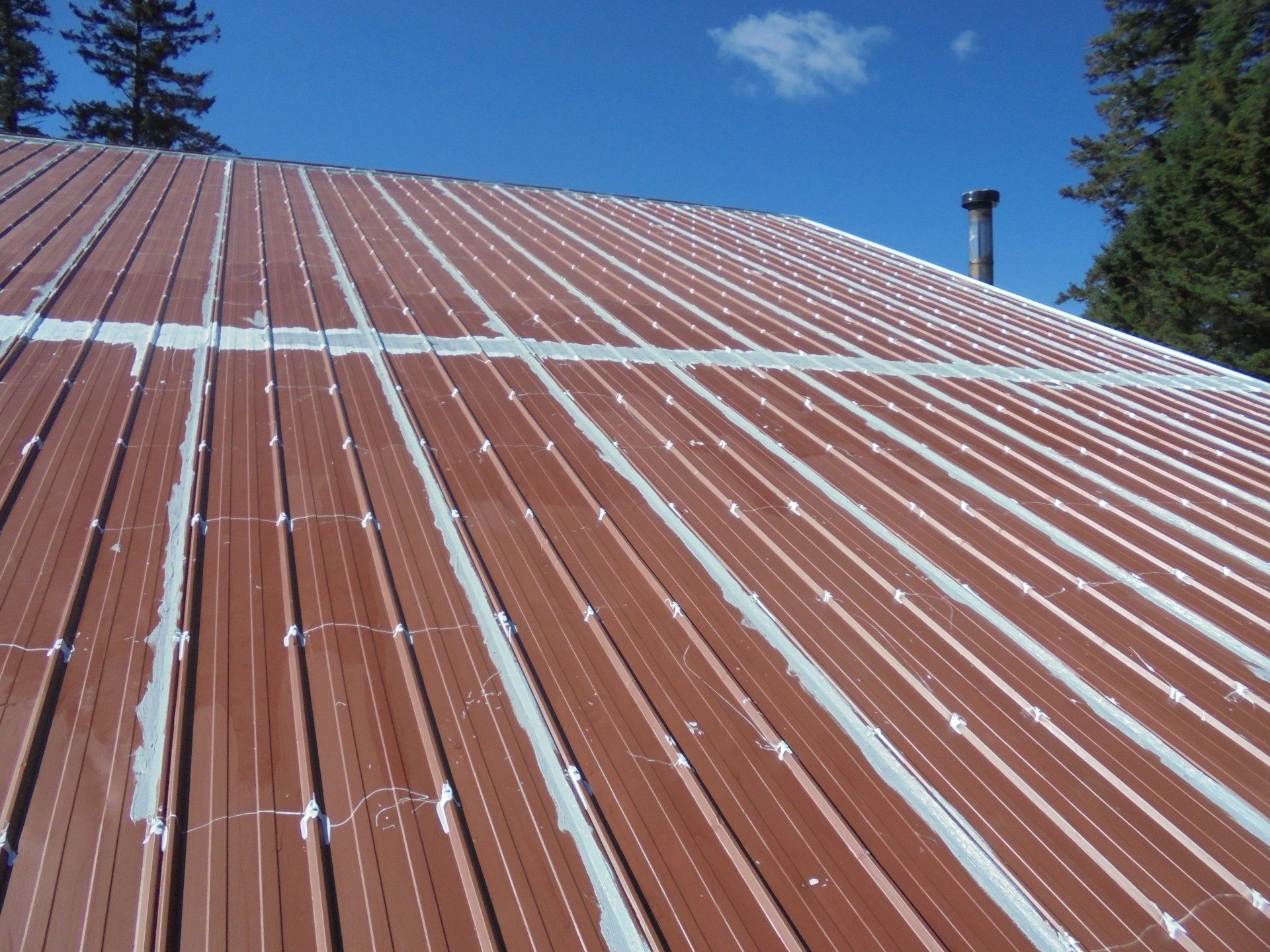 A brown metal roof with white stripes on it