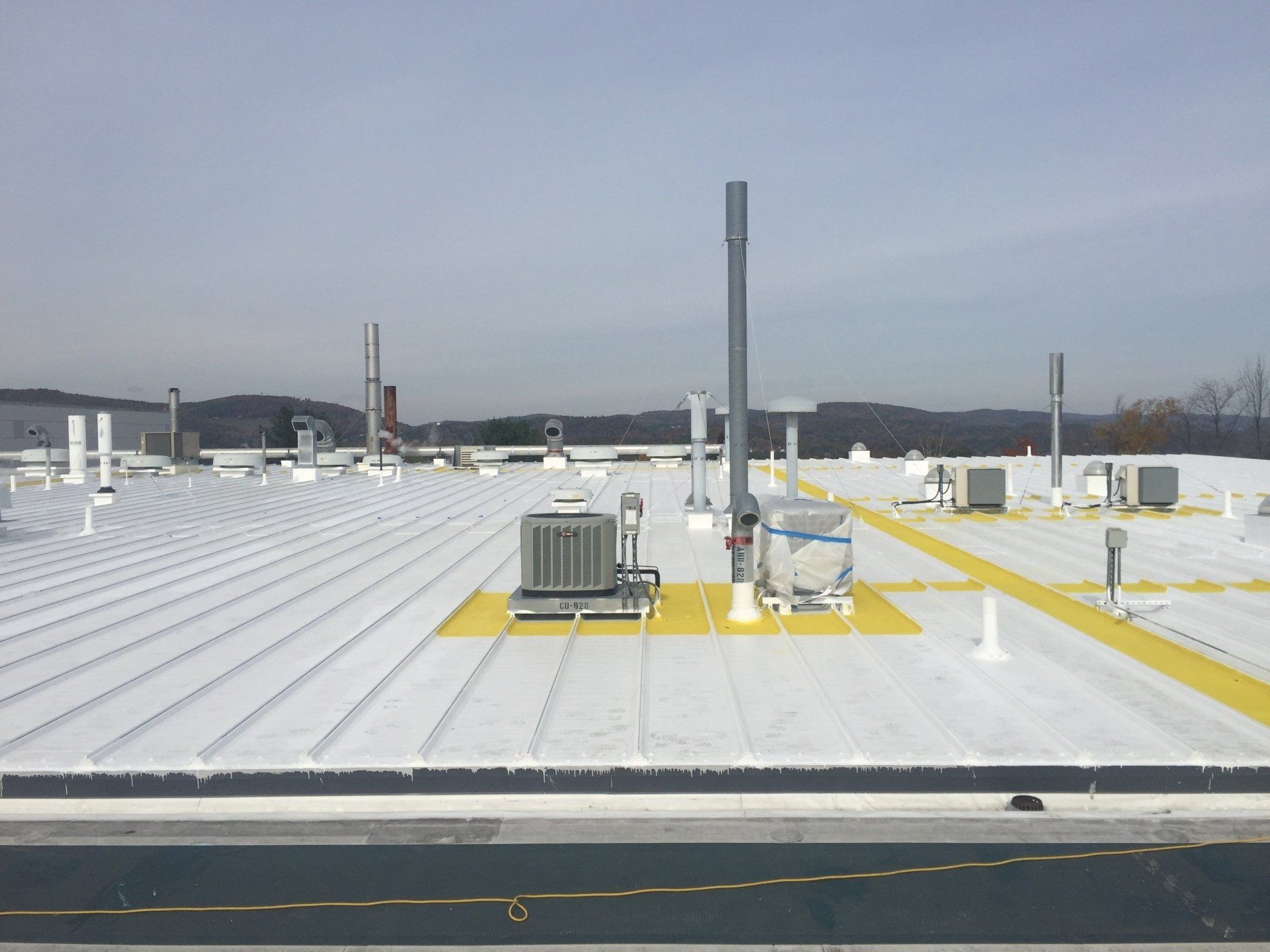 A white roof with a yellow stripe on it