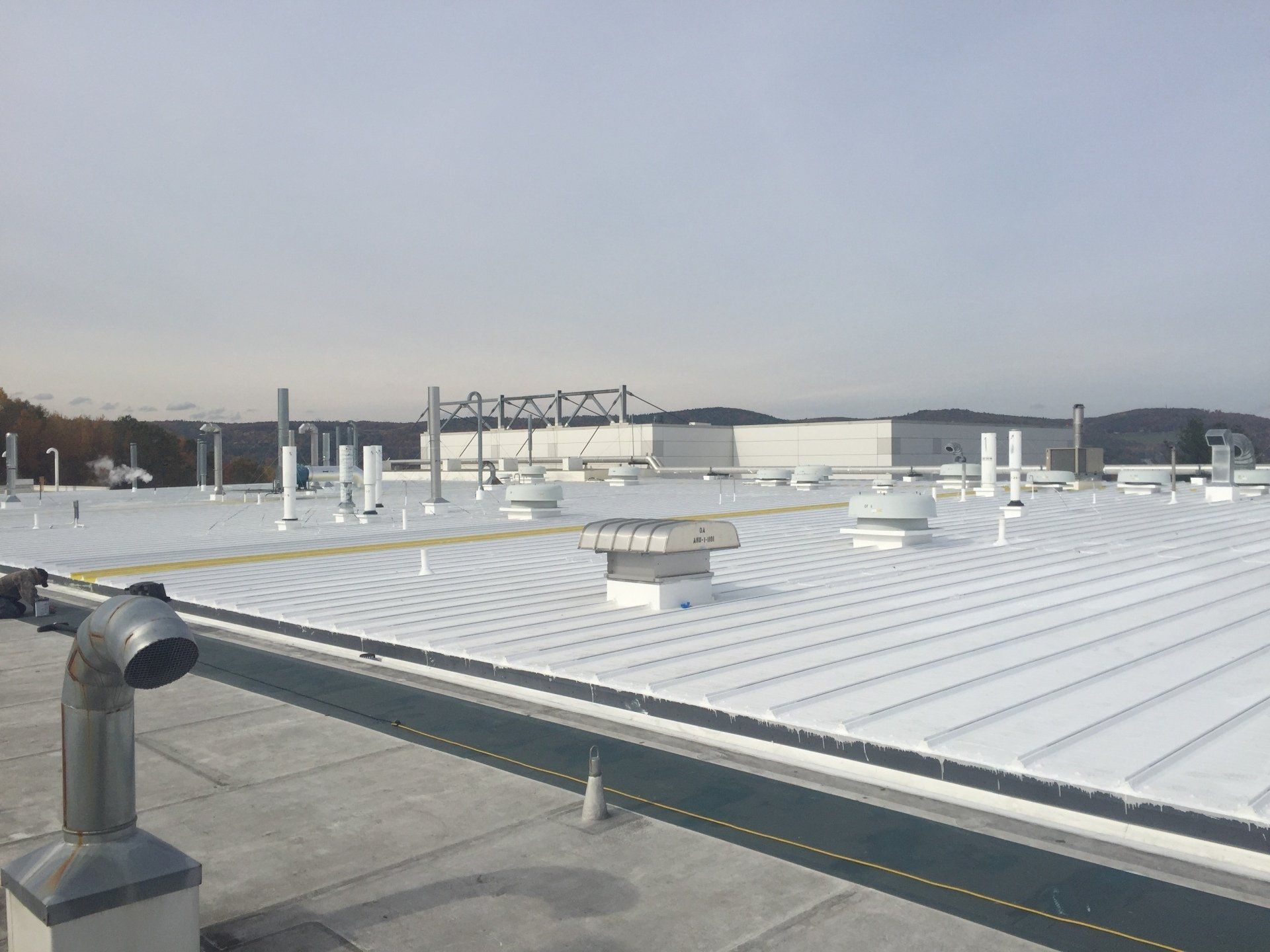 A large white roof with a lot of vents on it