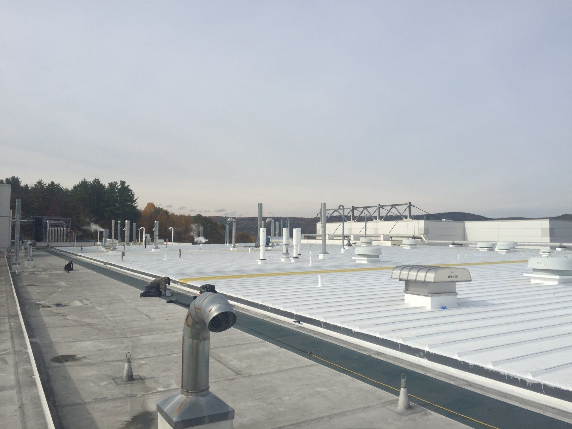 A large white roof with a lot of pipes on it