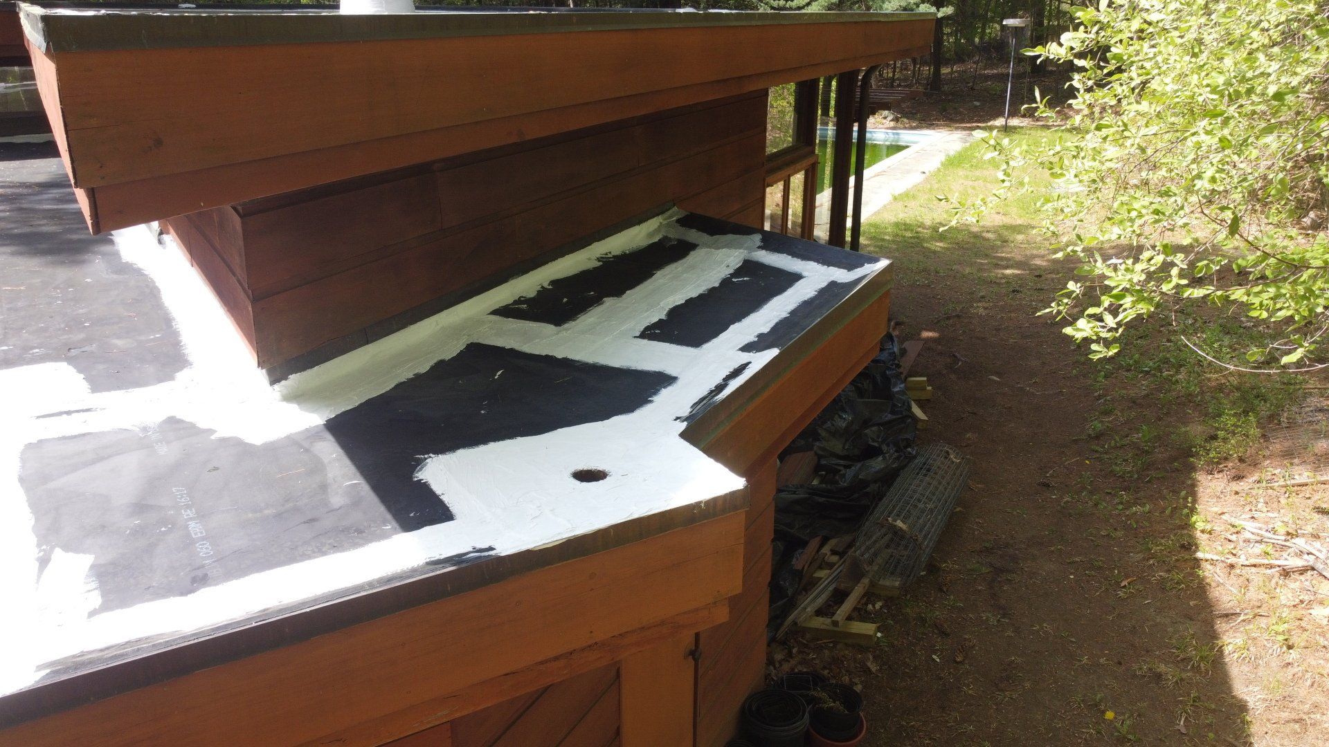 A wooden deck with a black and white pattern on it