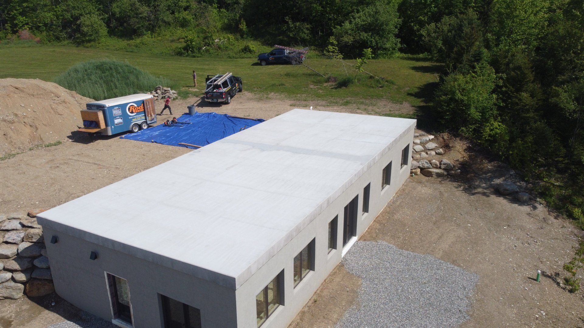 An aerial view of a building under construction in a dirt field.