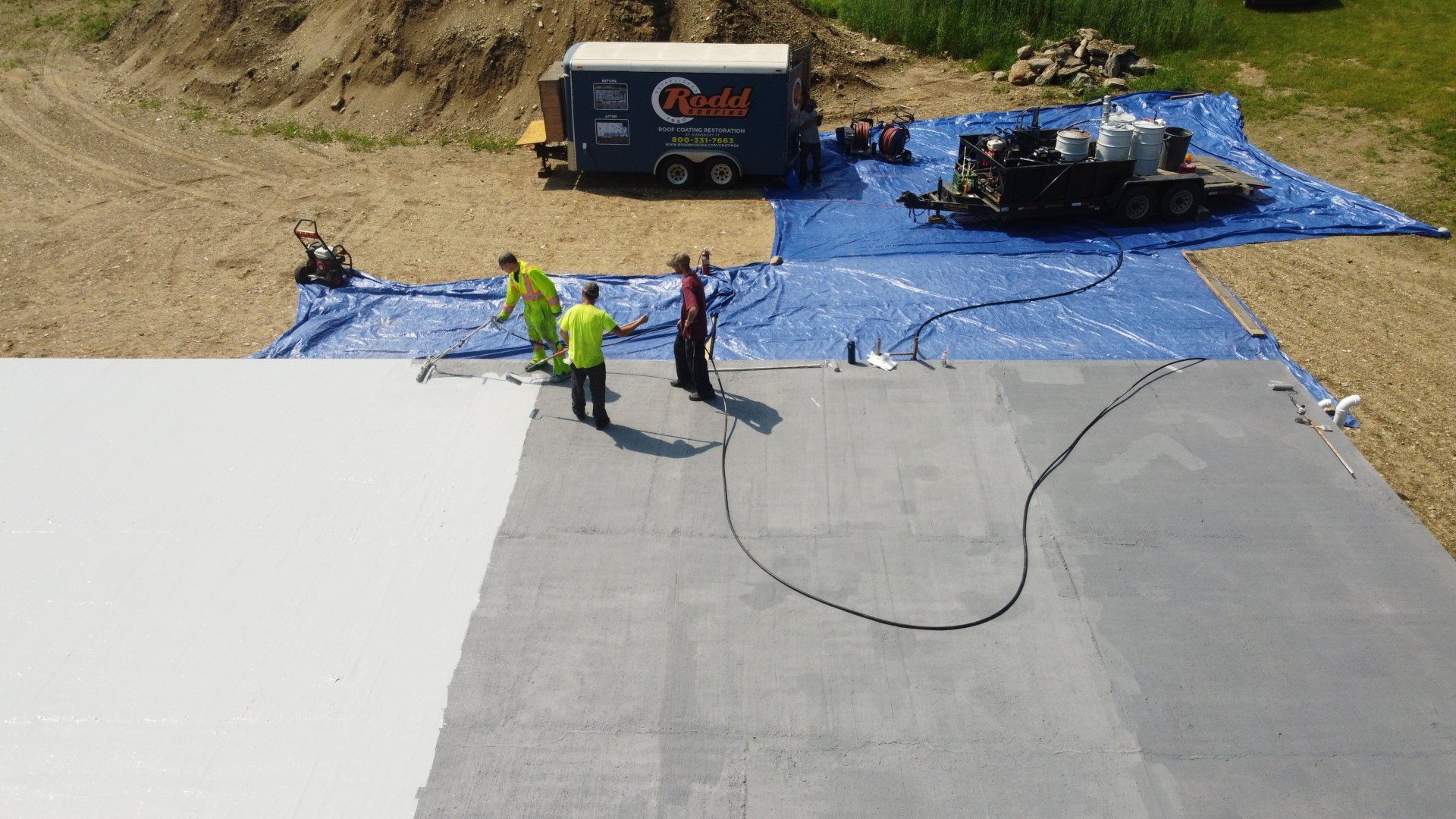 A group of construction workers are standing on top of a concrete floor.