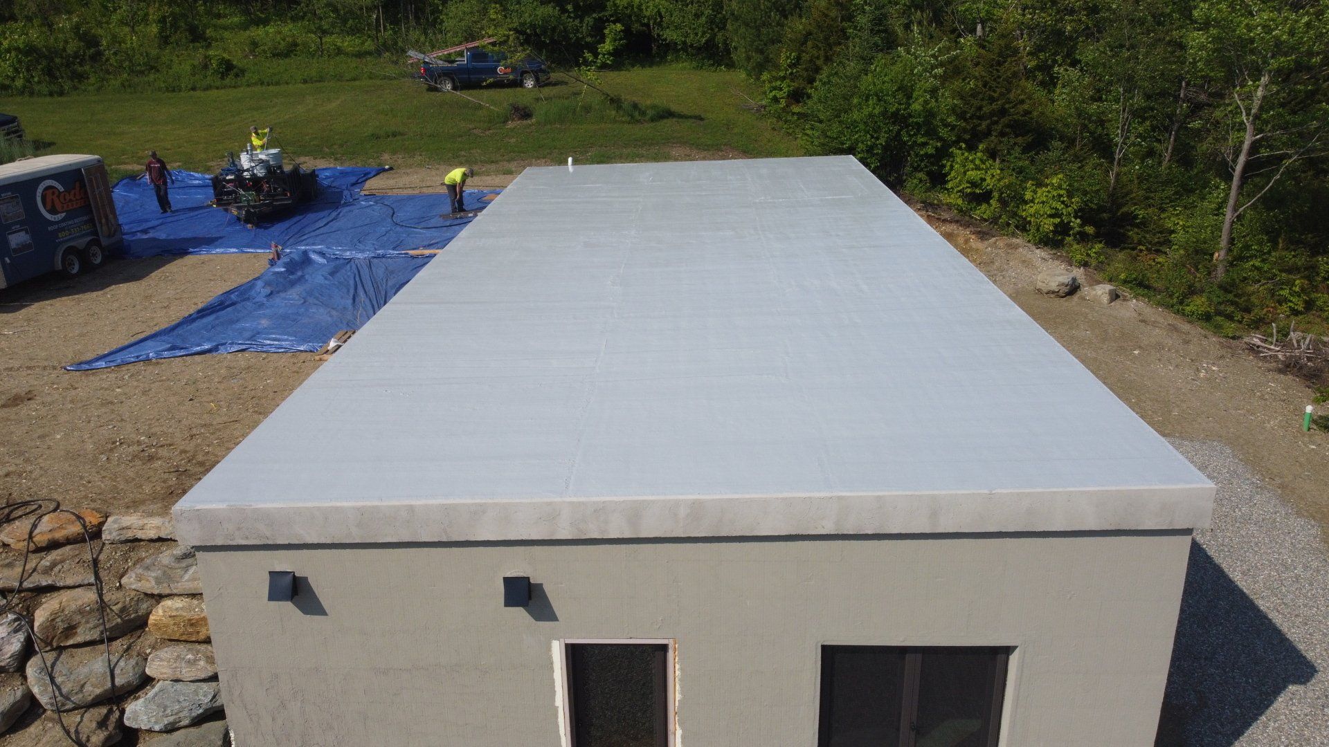 An aerial view of a building with a white roof.