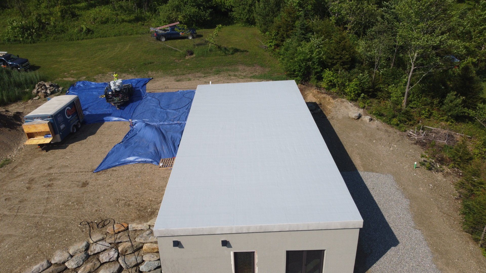 An aerial view of a building under construction in a field.
