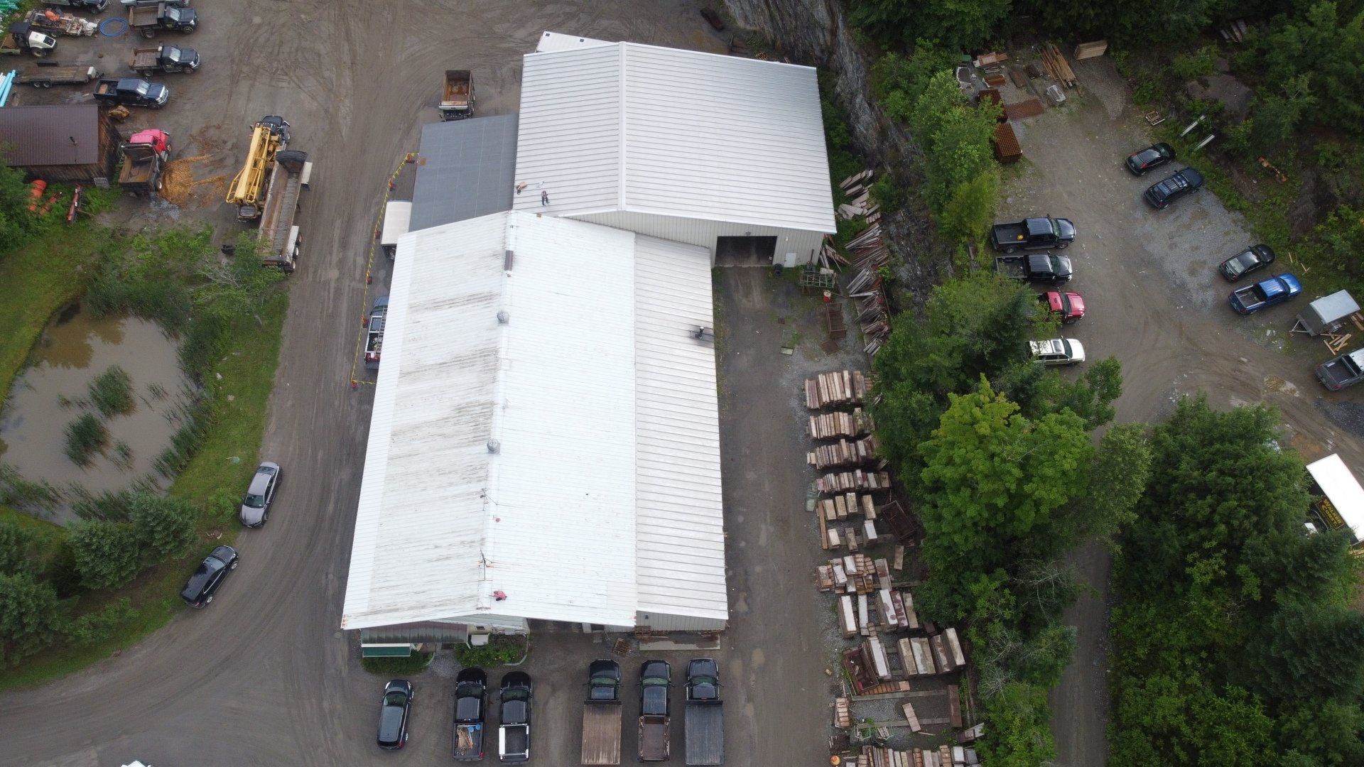 An aerial view of a large building with a lot of cars parked in front of it.