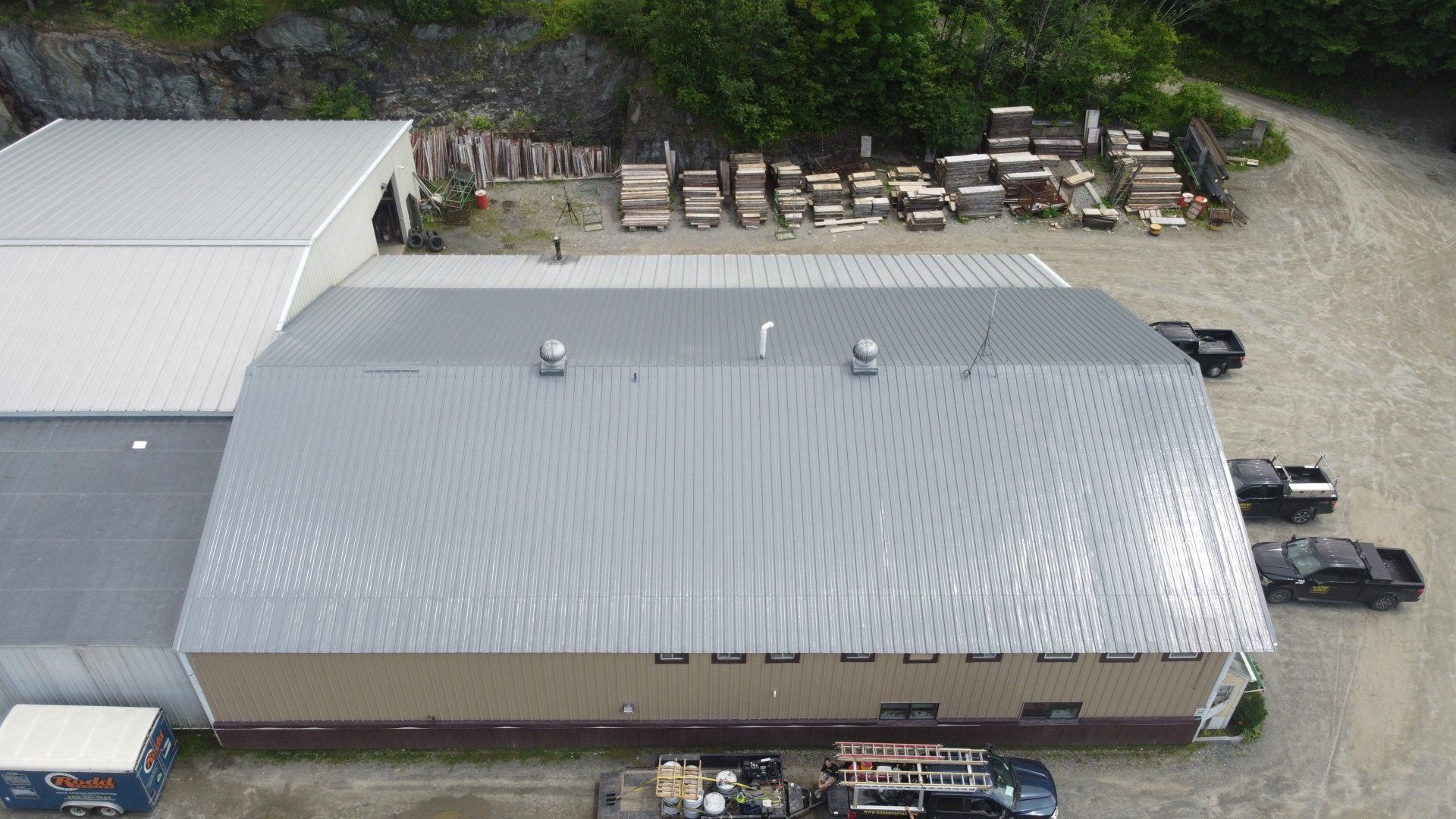 An aerial view of a large building with a metal roof.