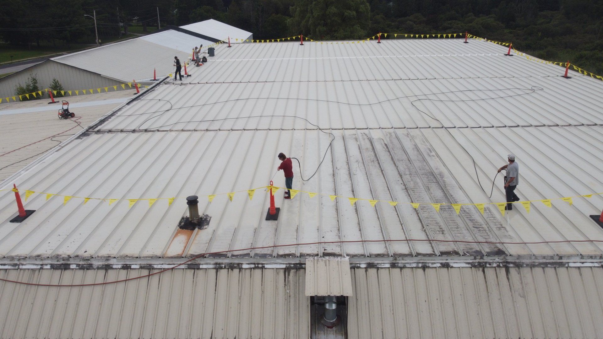 A group of people are working on the roof of a building