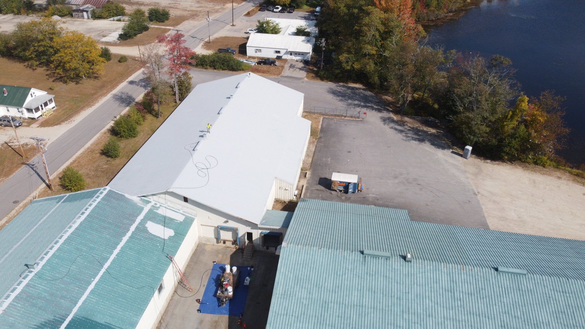 An aerial view of a large building next to a body of water.