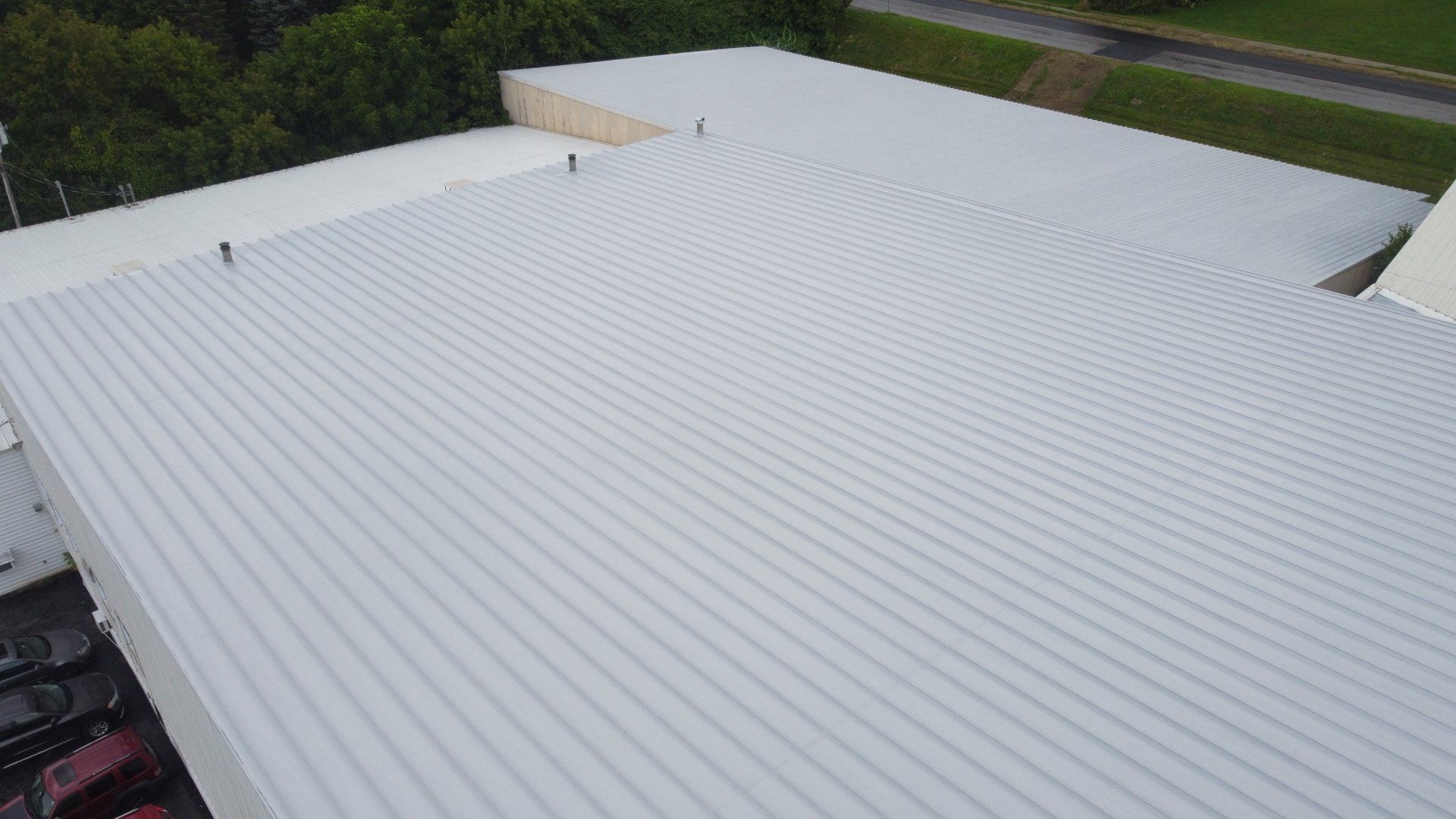 An aerial view of a white roof of a building.
