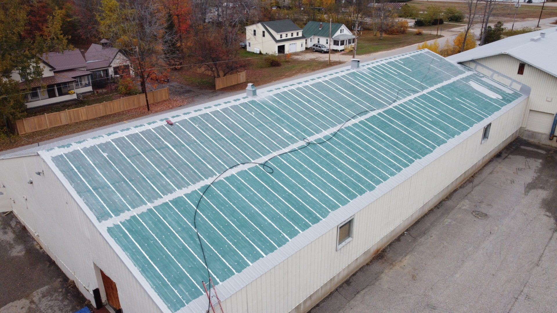 An aerial view of a large building with solar panels on the roof.