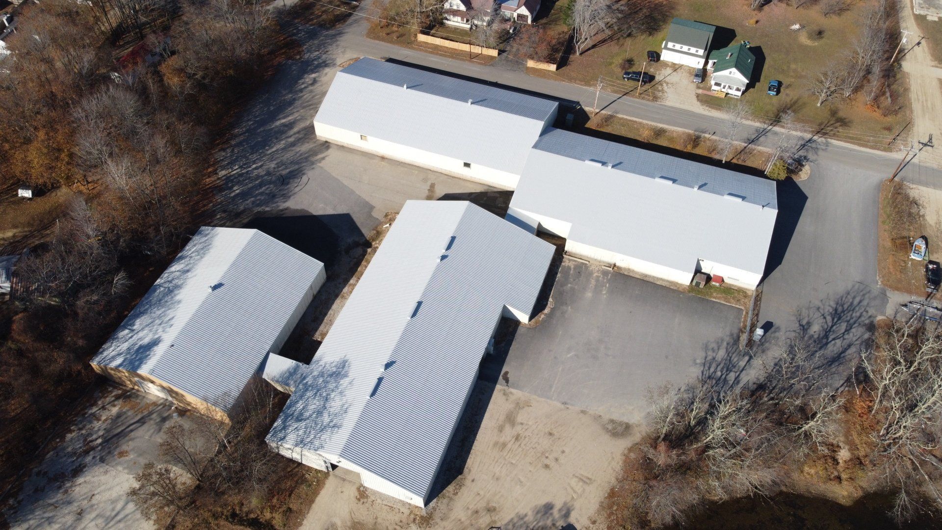 An aerial view of a building with a white roof