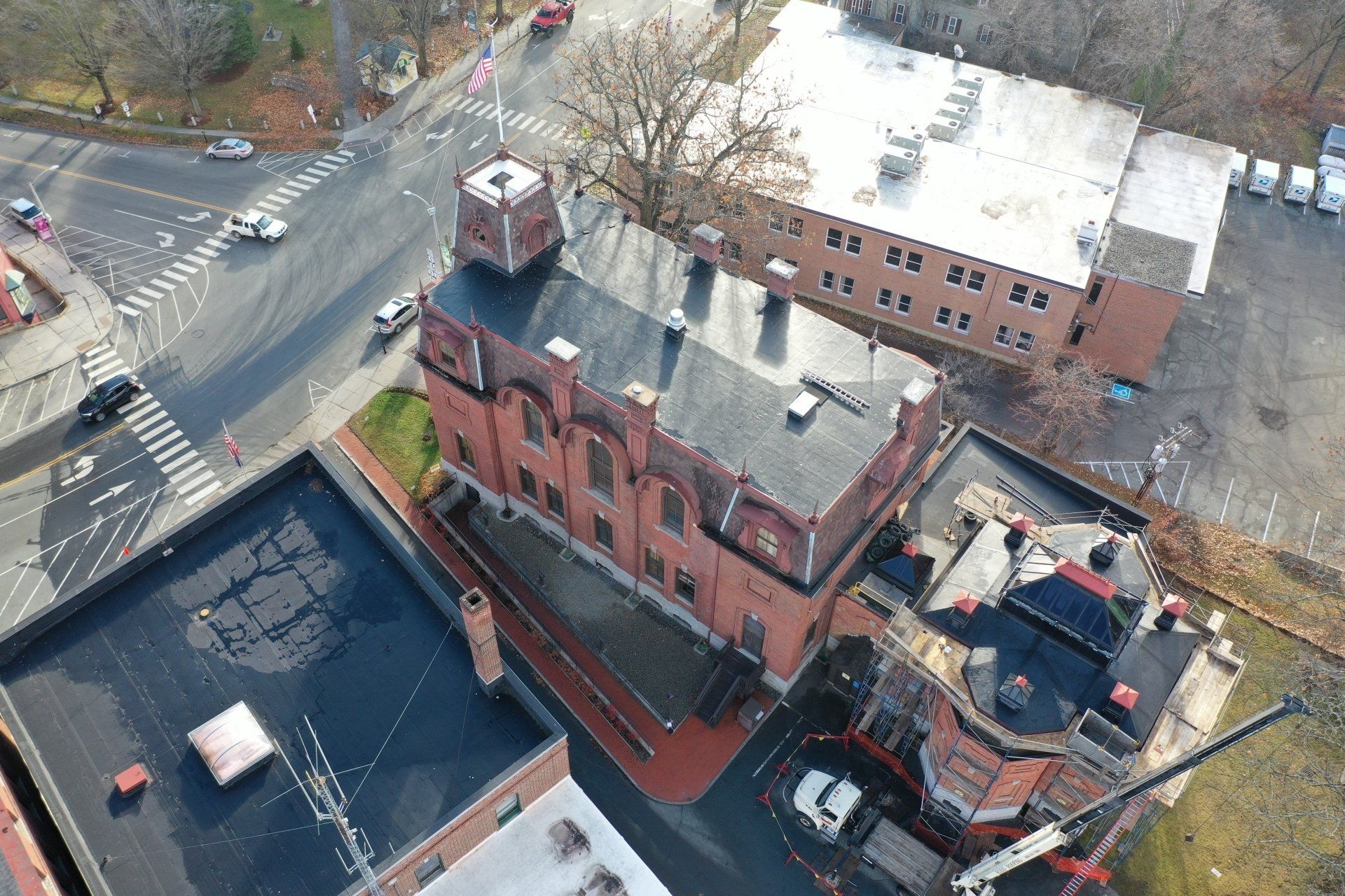 Aerial view of a brick building with black single-ply  roof