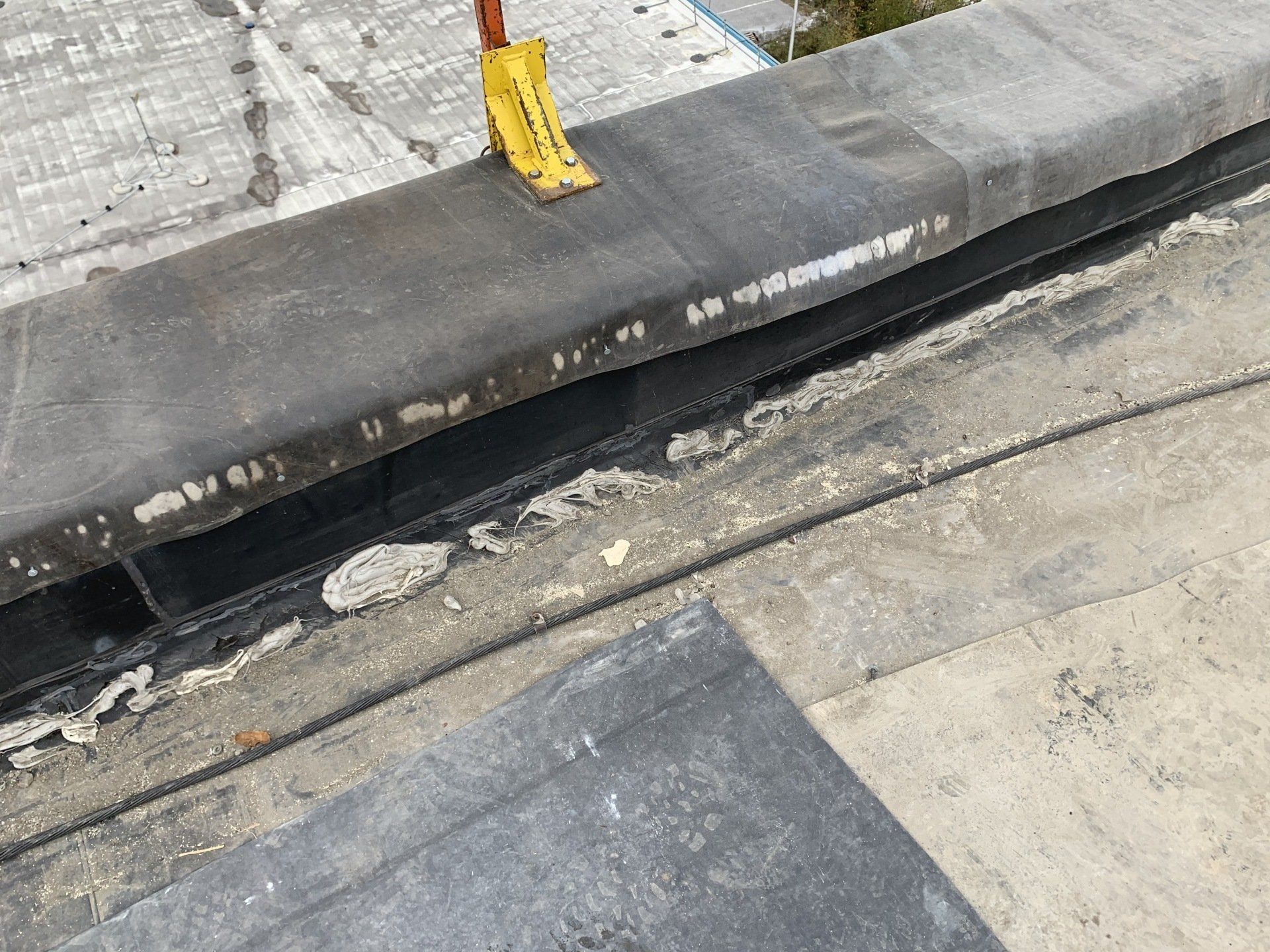 A close up of a roof with a yellow sign on it.