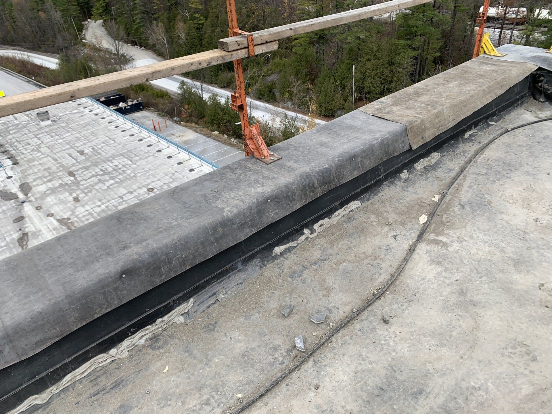 A roof with a wooden railing on top of it.