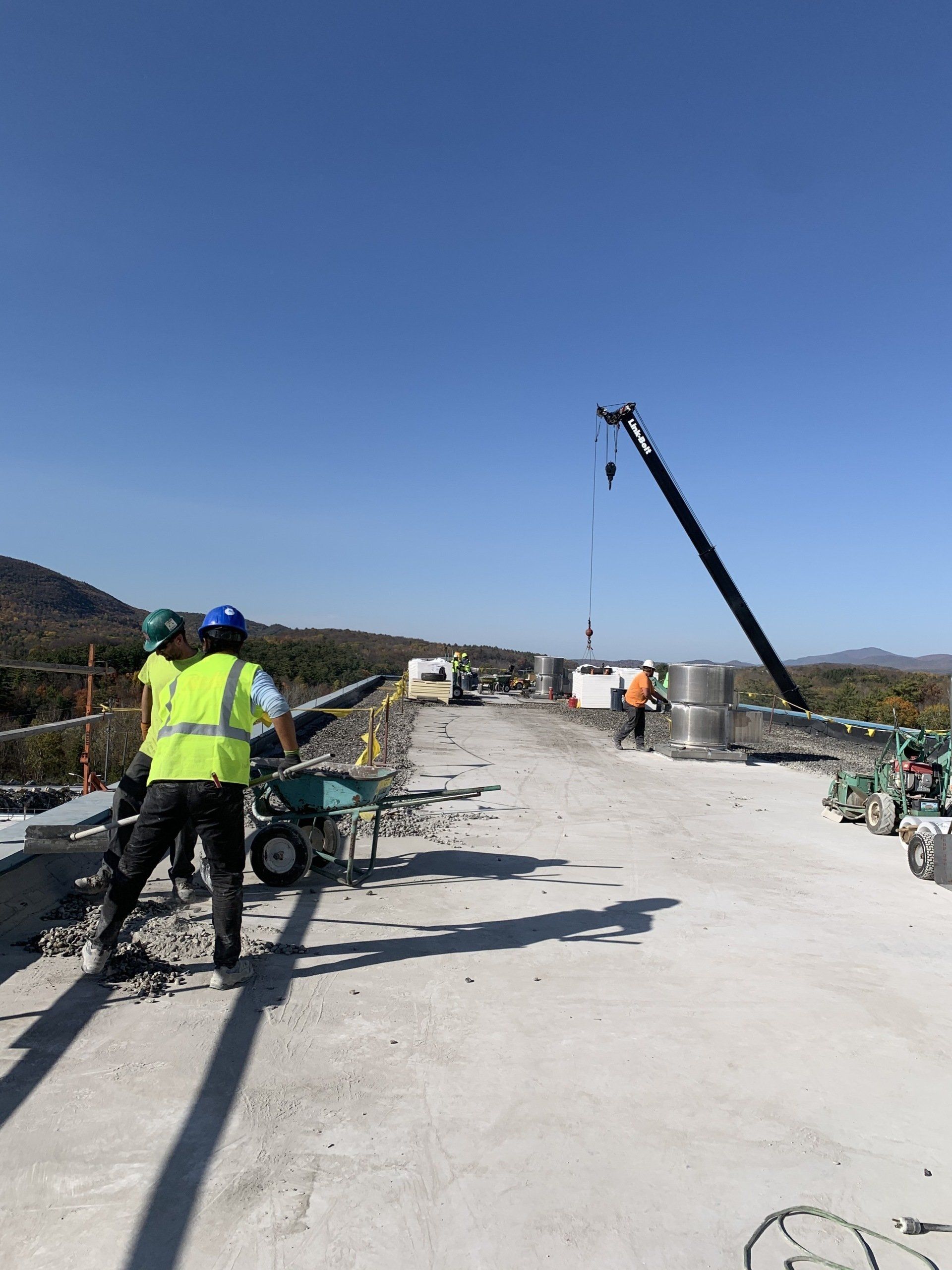A group of construction workers are working on a bridge.
