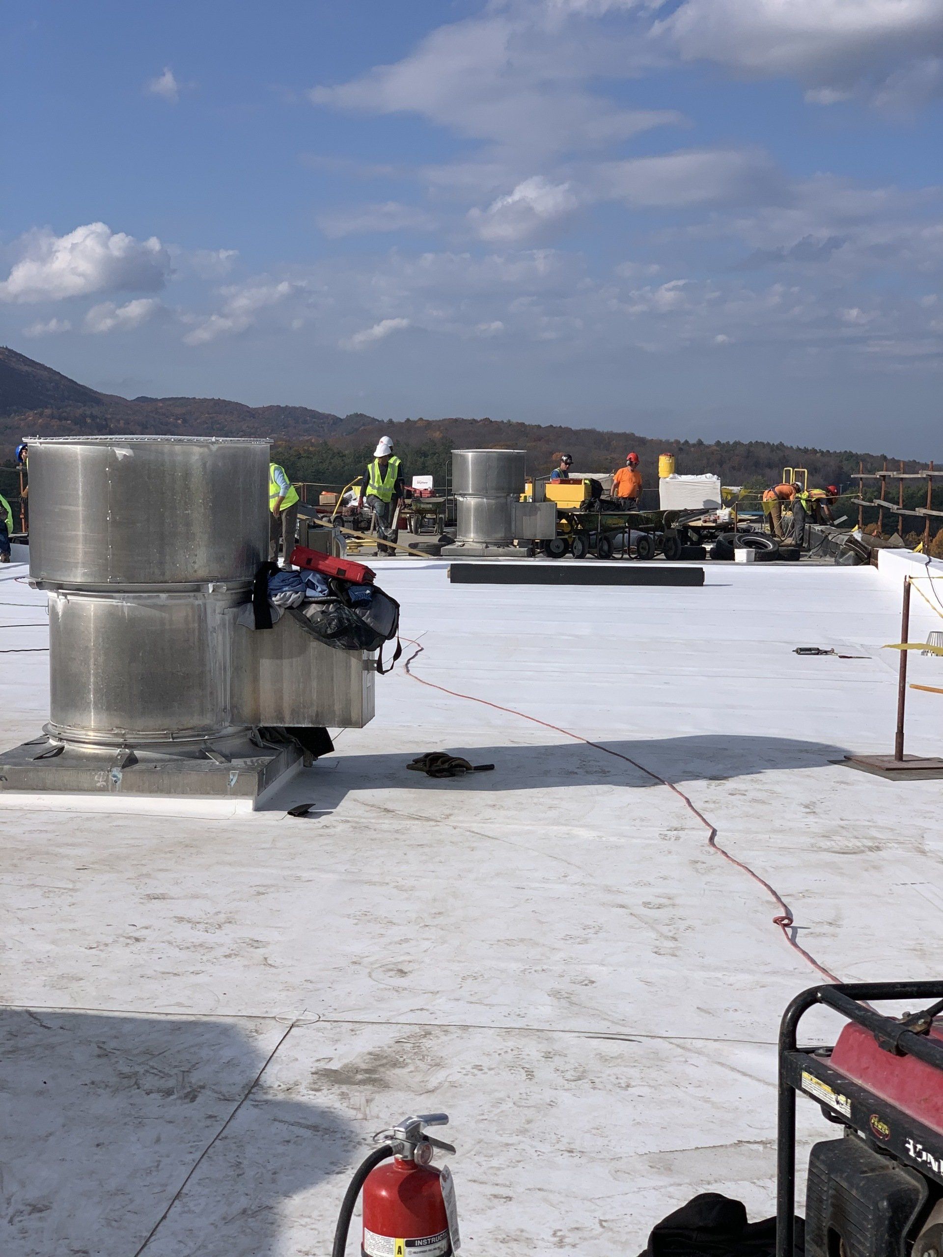 A fire extinguisher is sitting on the roof of a building