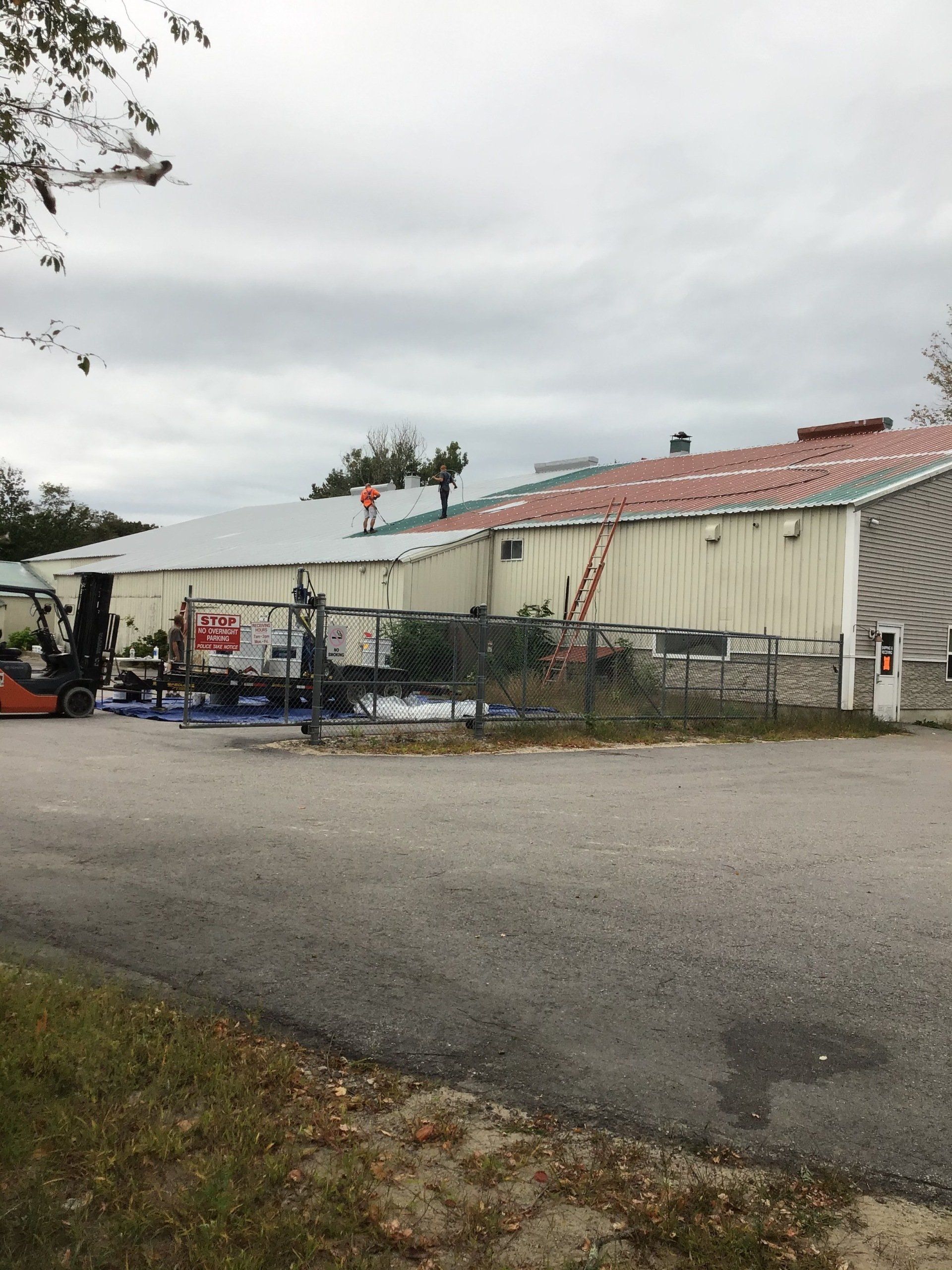 A forklift is parked in front of a large building.
