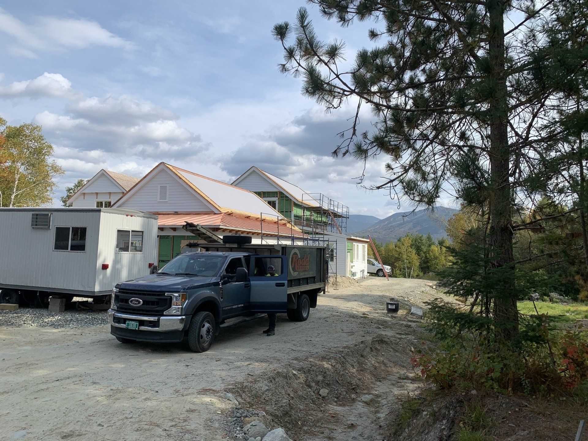 Rodd Roofing truck hauling supplies to a residential house roof
