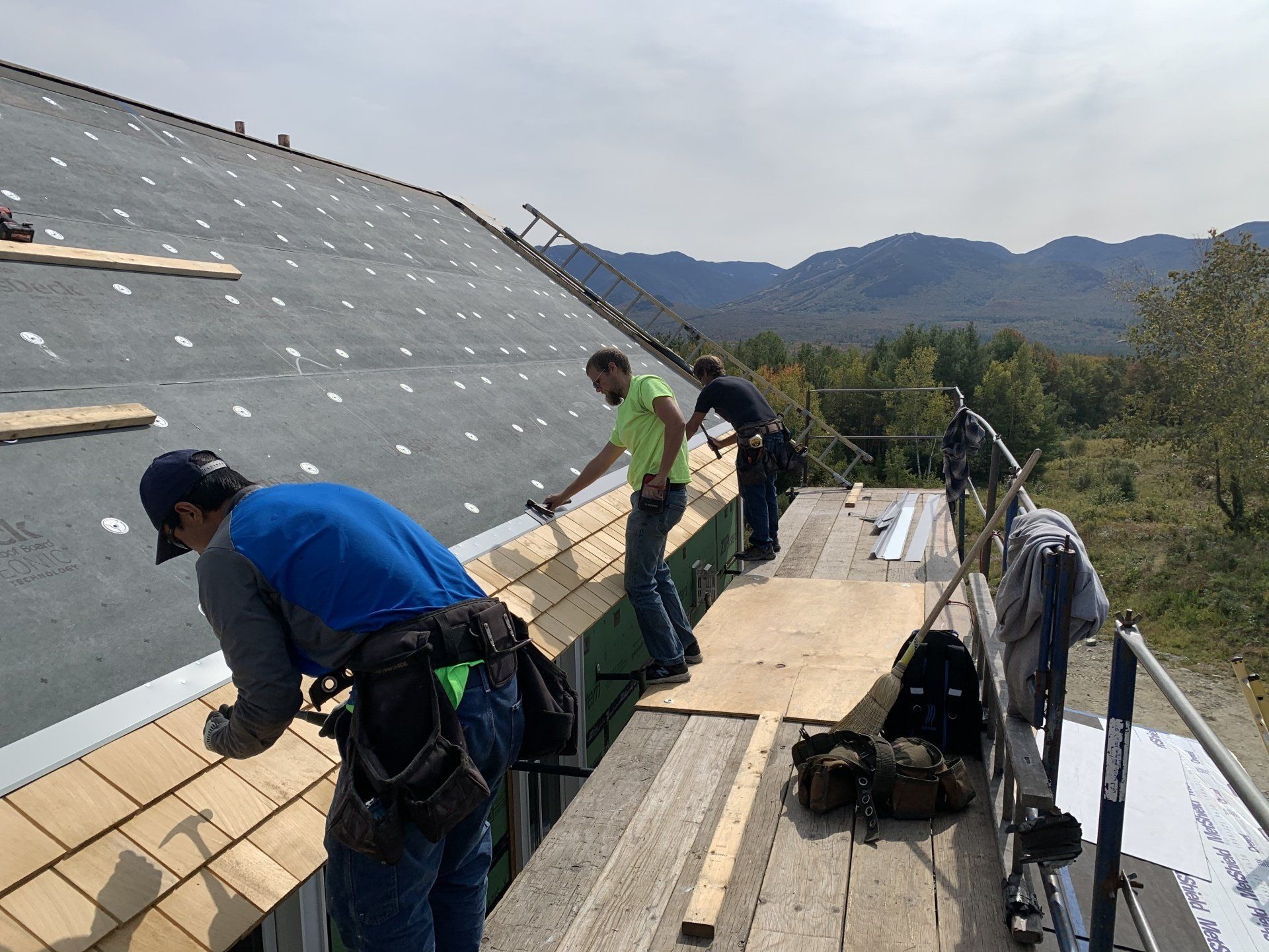 Rodd Roofing employees installing a residential wood shingles roof