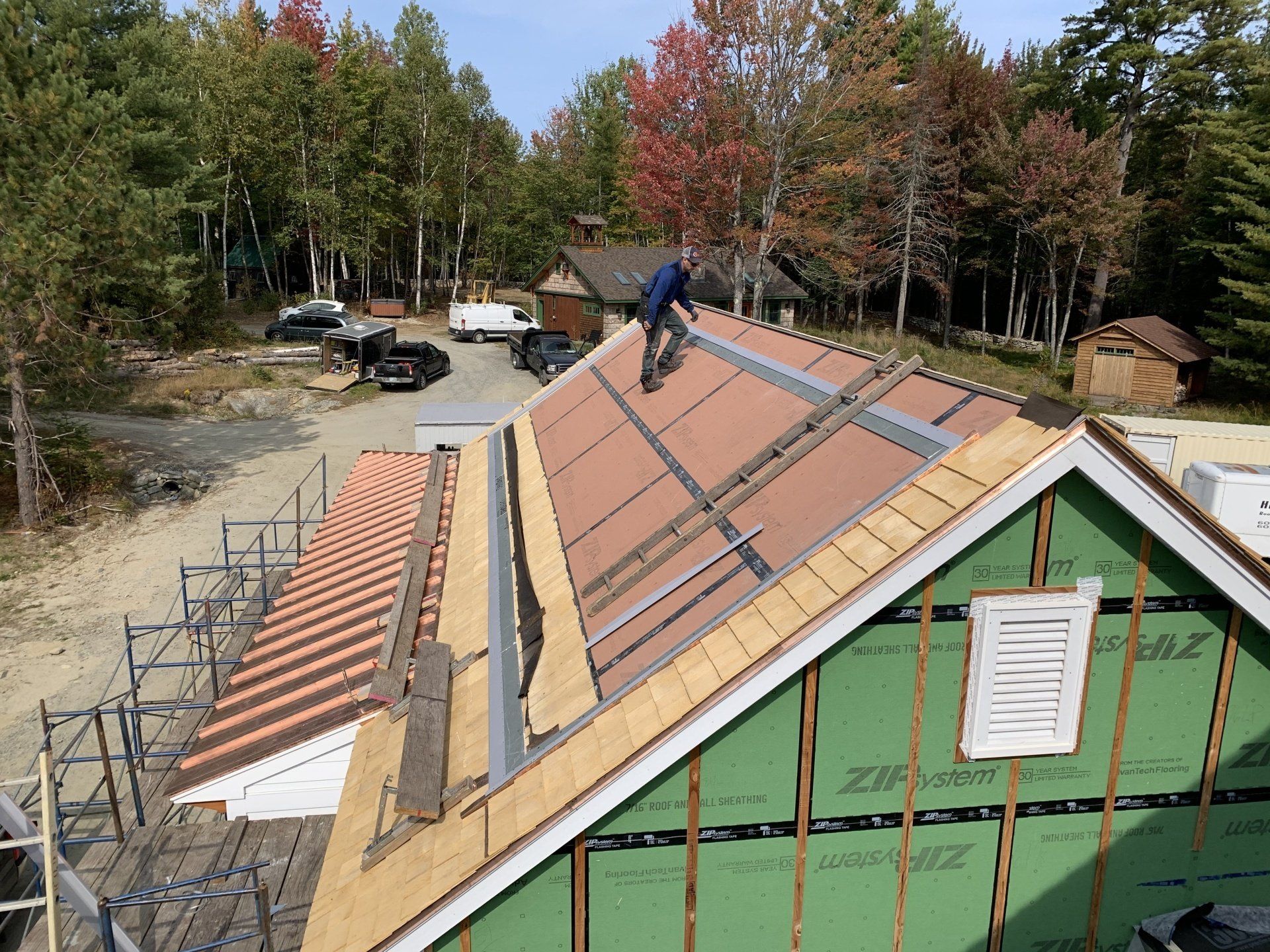A man is working on the roof of a house