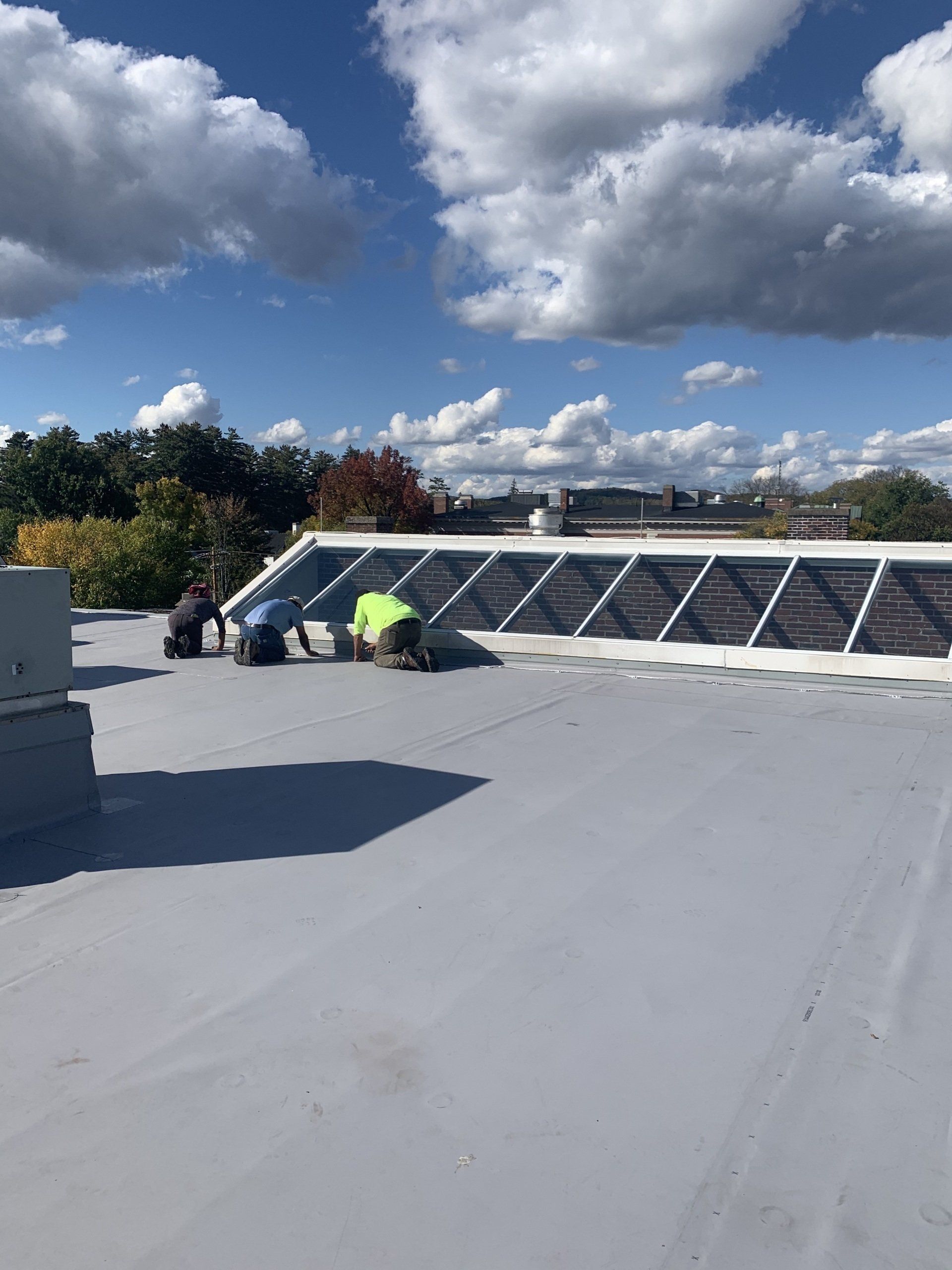 A group of people are working on a roof.