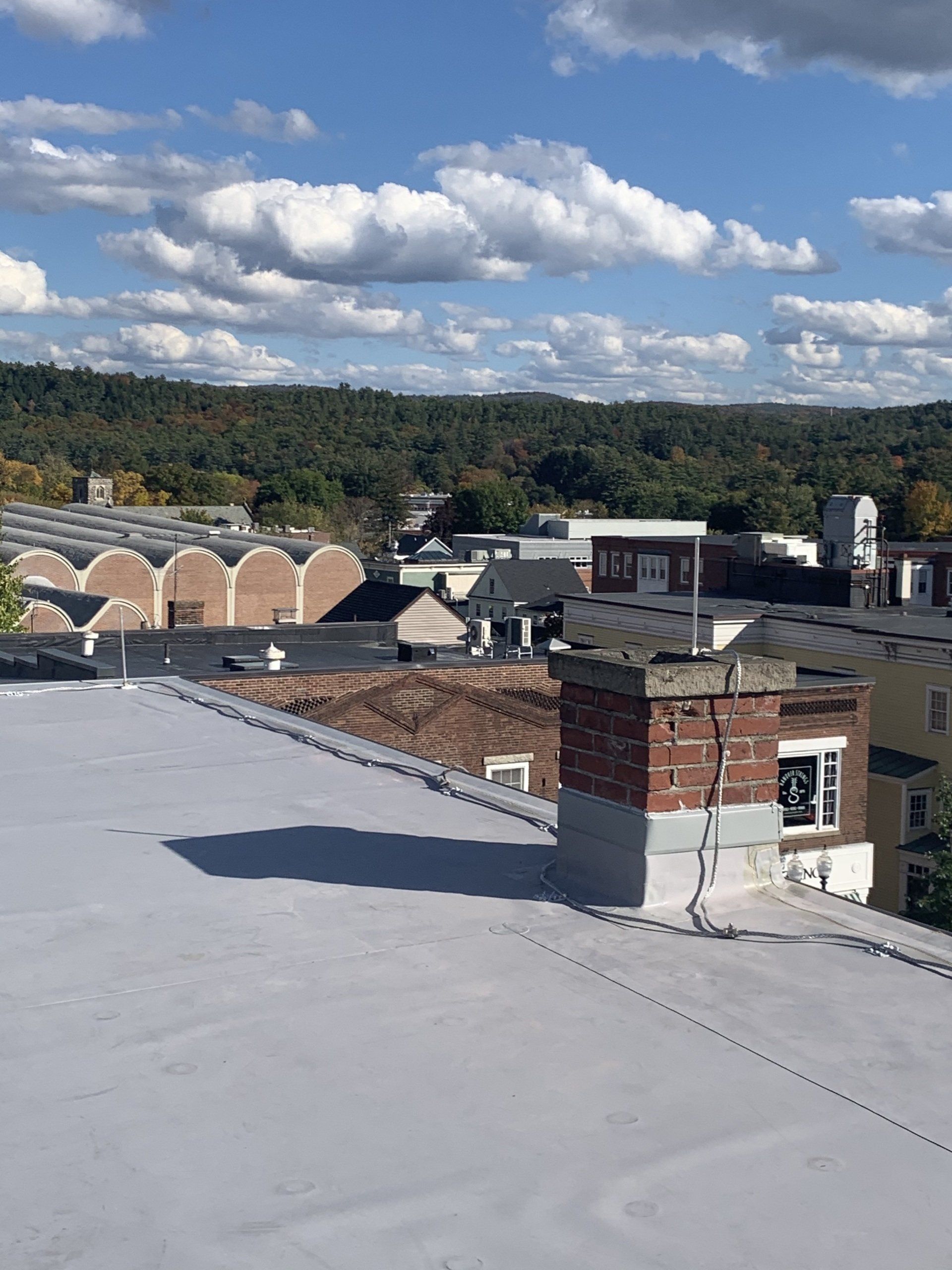 A view of a city from the roof of a building.
