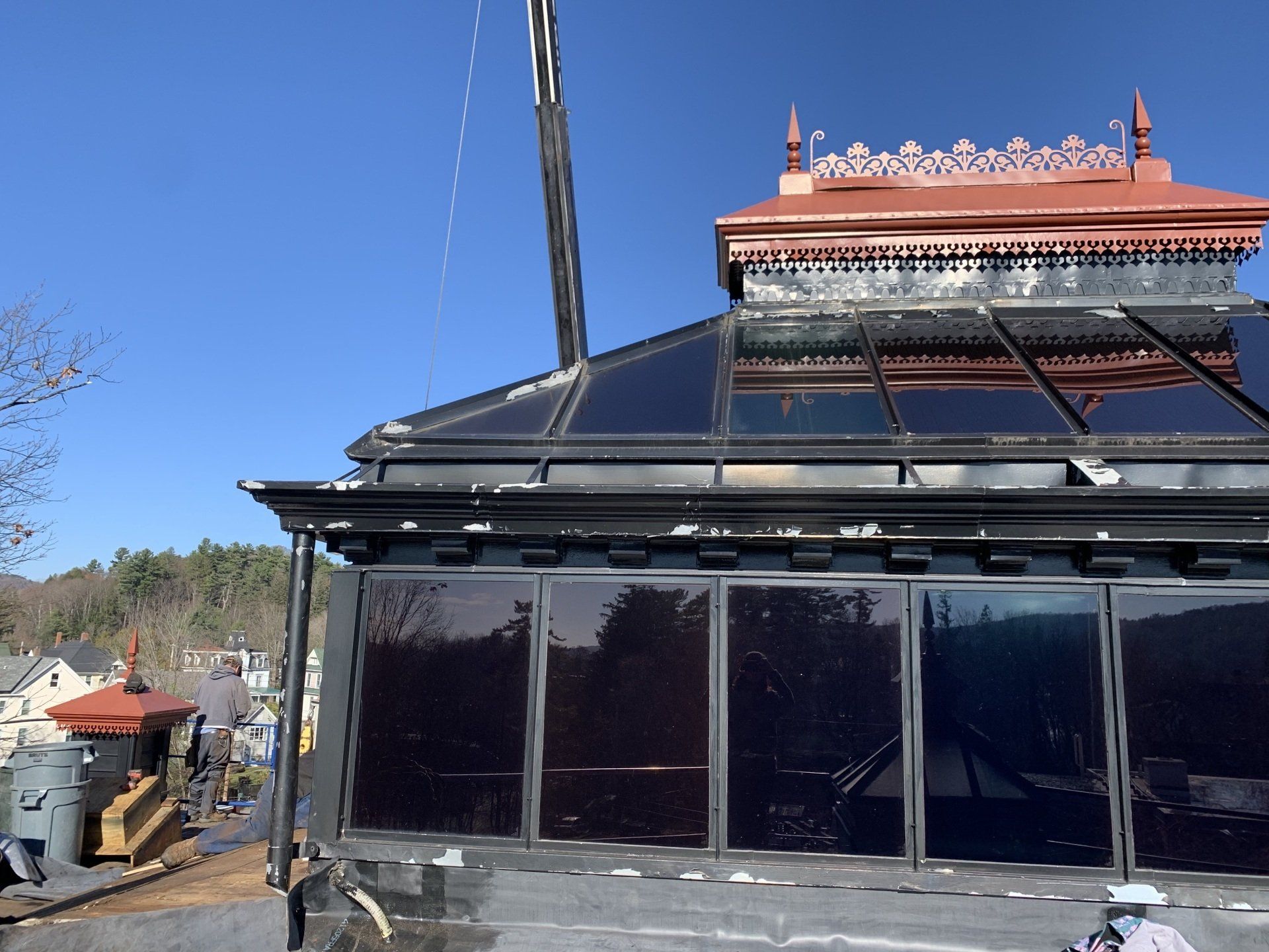 single-ply projects - Solar panels on a building’s roof against a clear blue sky.