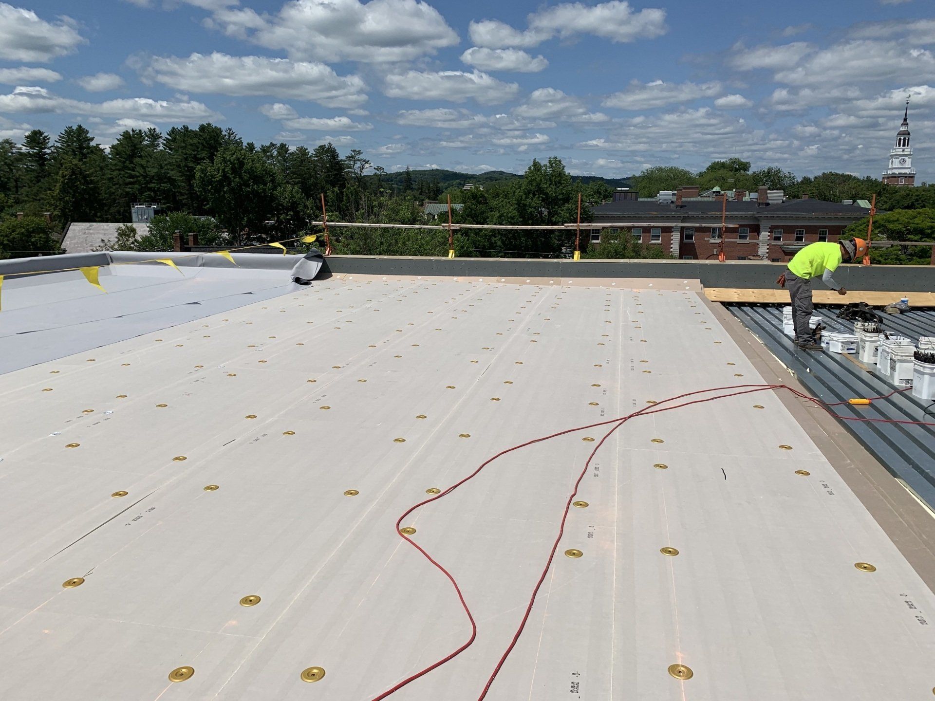 A man is working on the roof of a building.