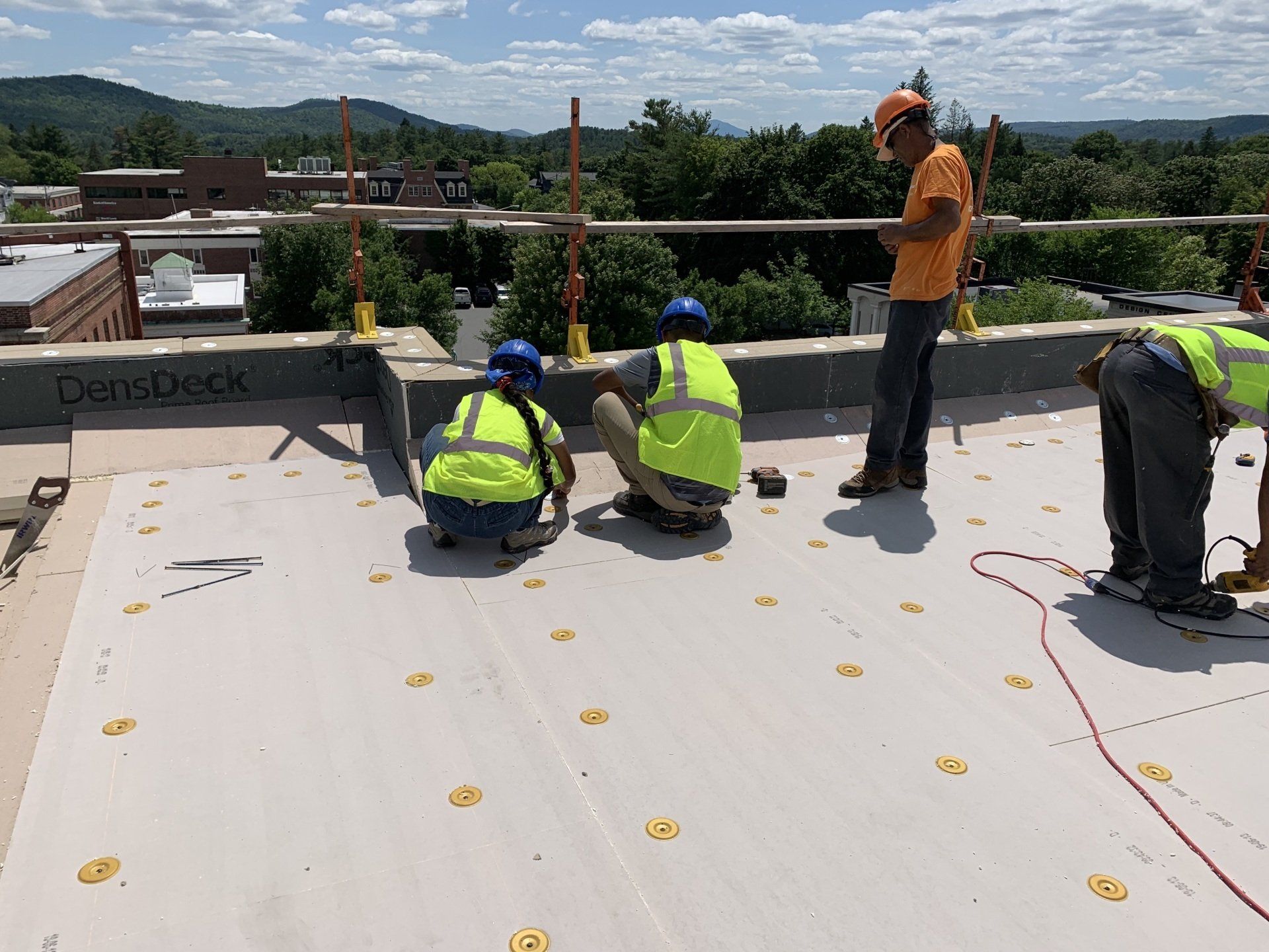 Rodd Roofing employees installing a single ply roof in Vermont