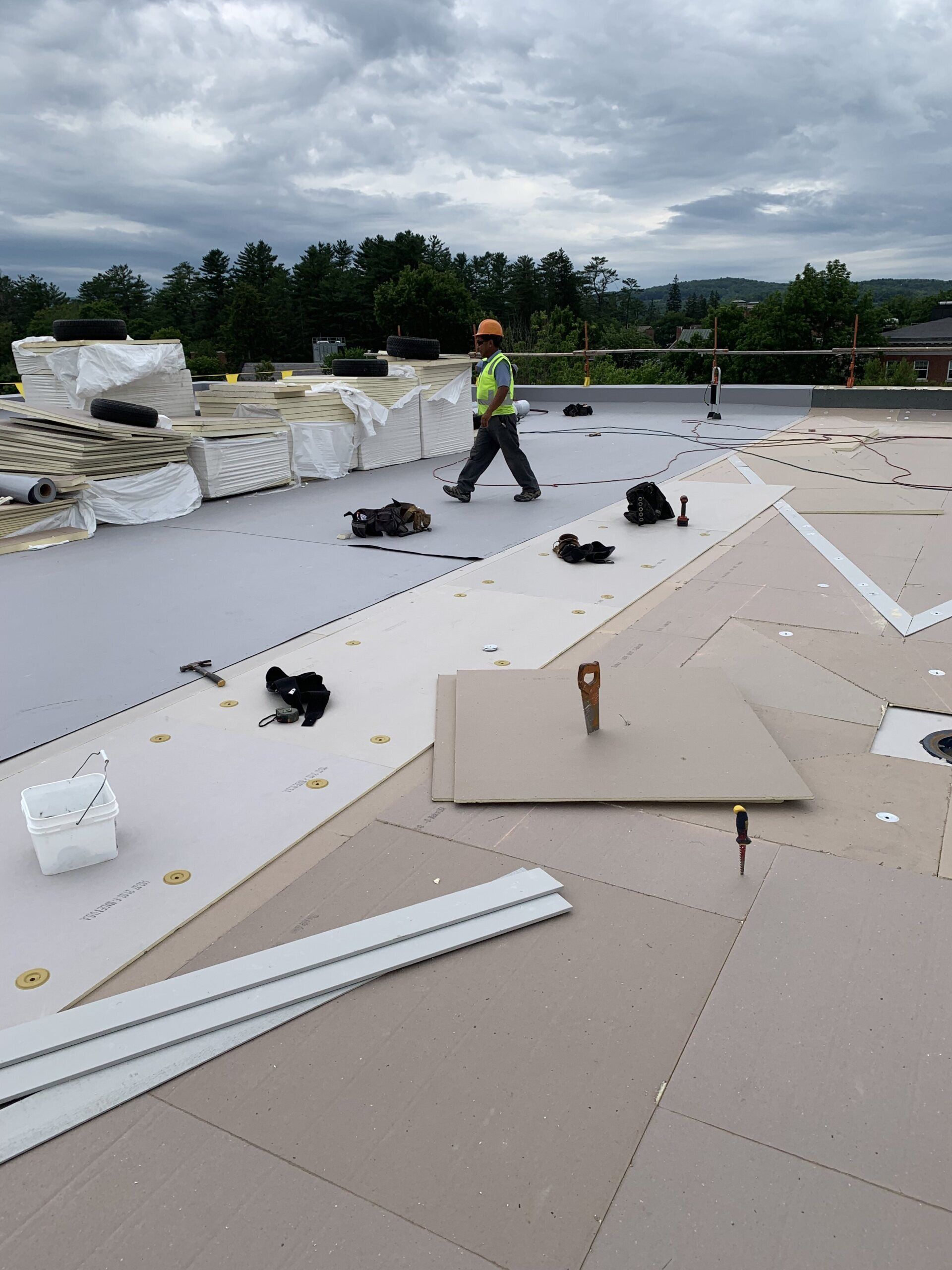 Rodd Roofing employee on a roof undergoing a single ply membrane installation in Vermont