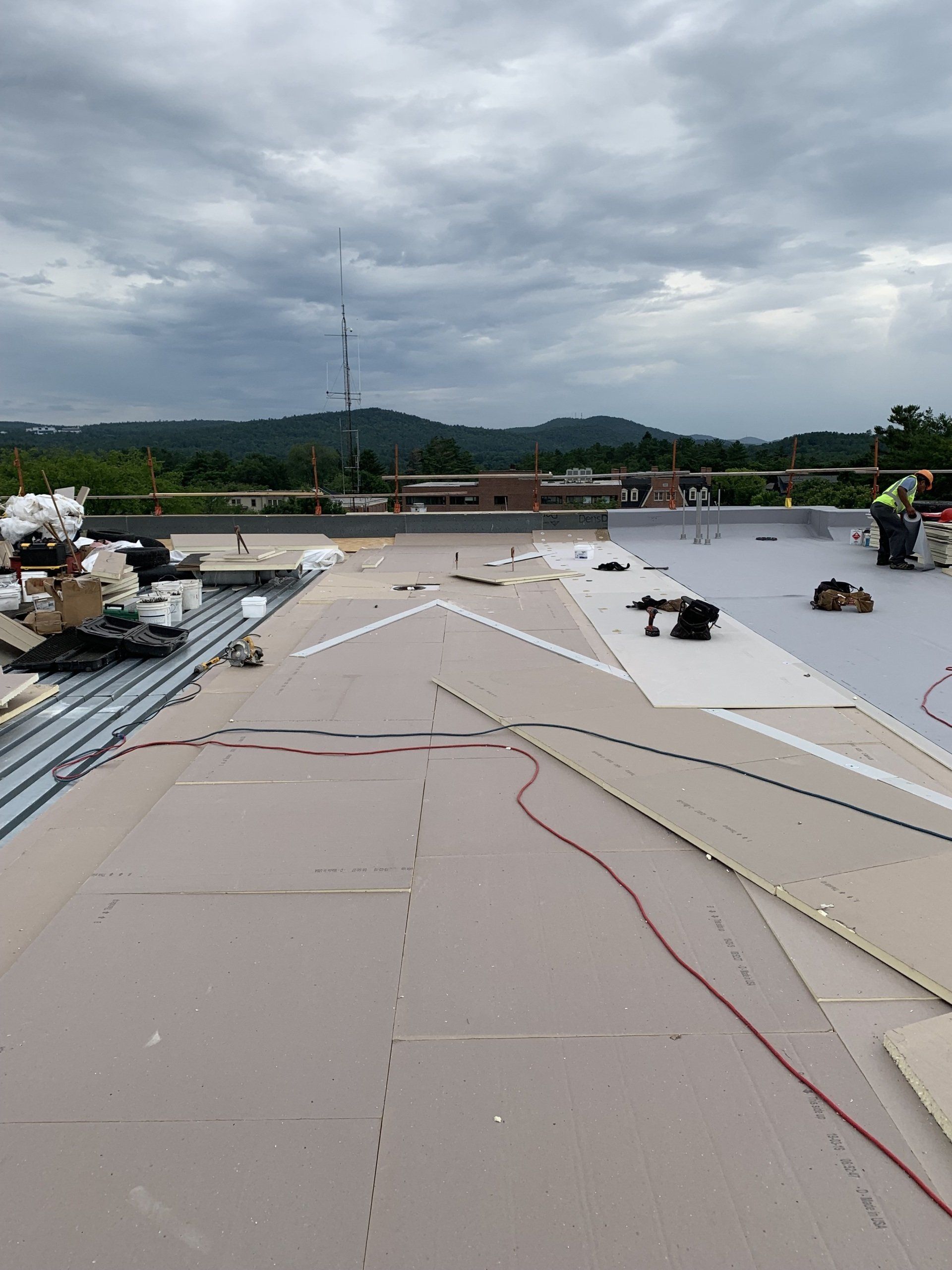 A roof with a lot of wires on it is being installed.