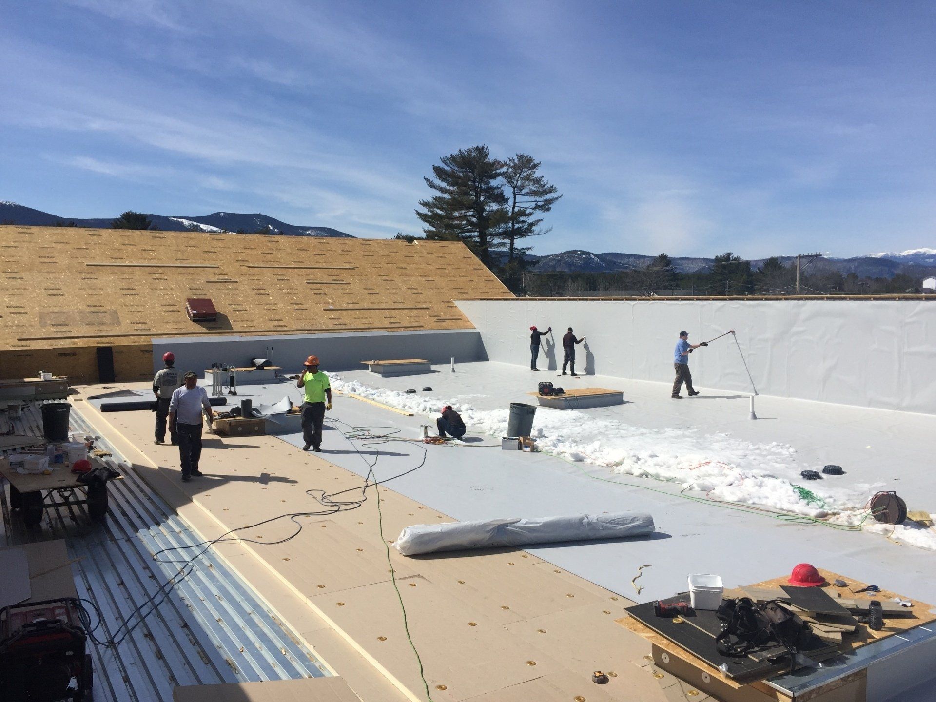 A group of people are working on a roof.