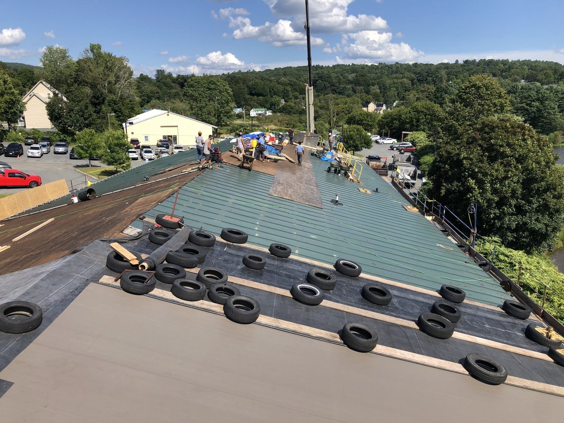 A group of people are working on the roof of a building.