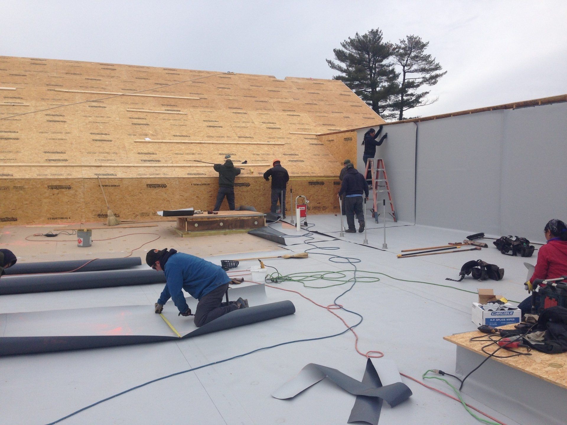 A group of people are working on a roof