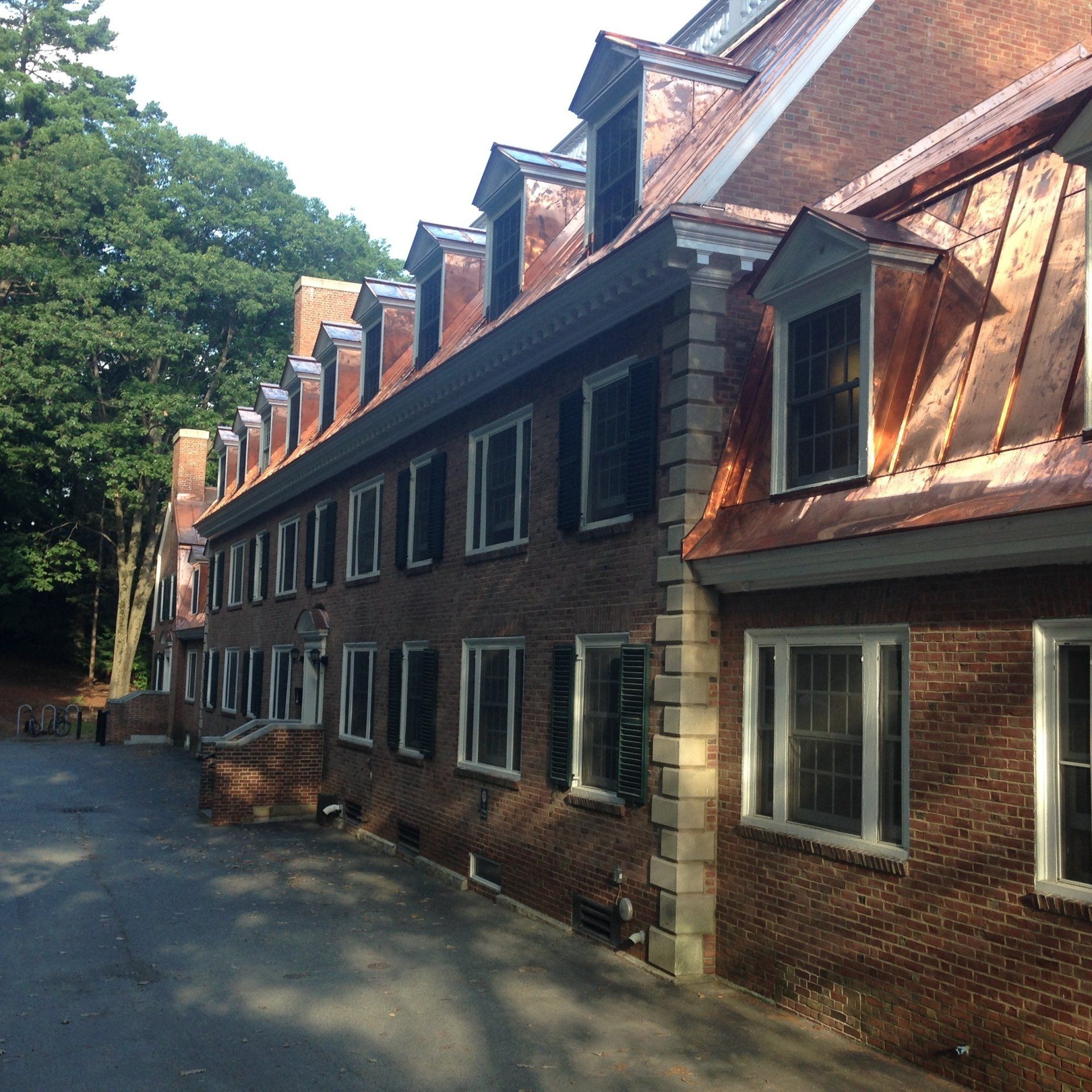A large brick building with a copper roof