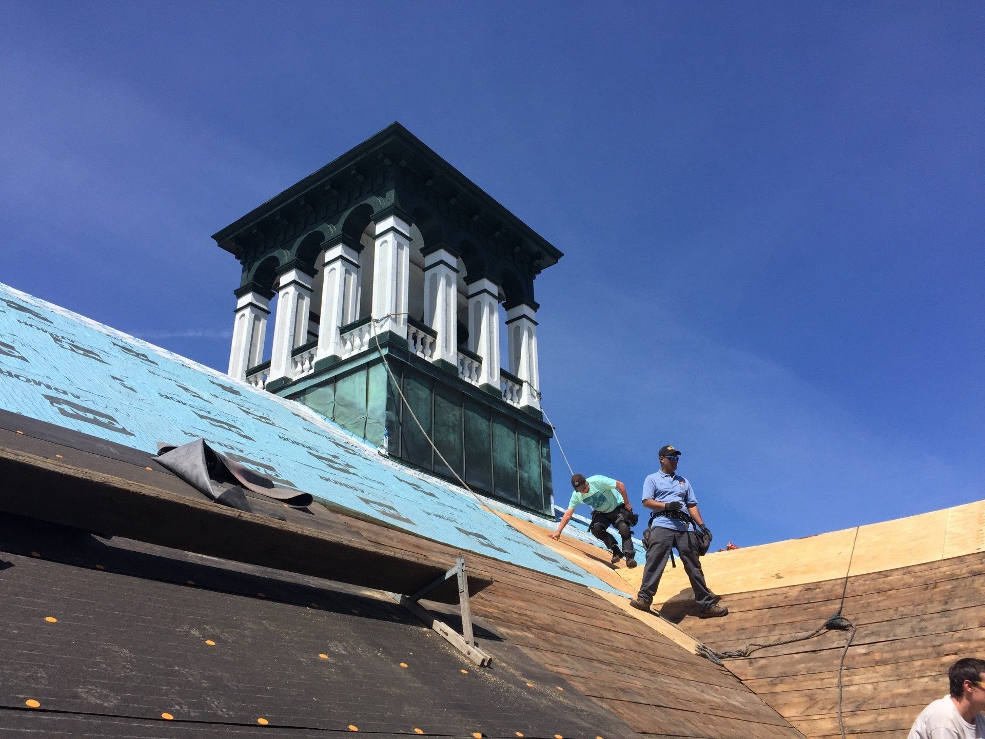 Rodd Roofing employees prepping a commercial roof getting it ready for a new slate roof