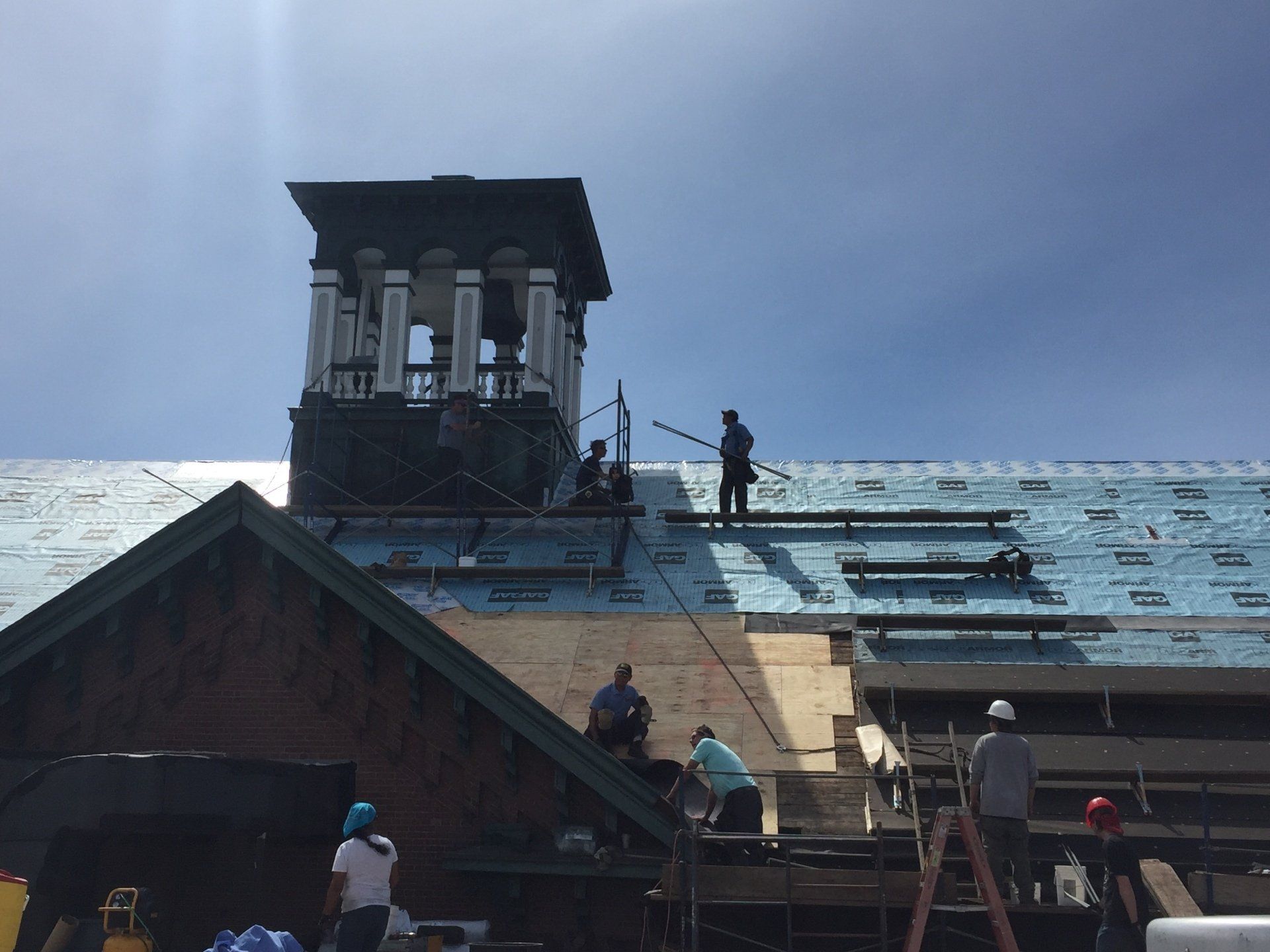 Rodd Roofing employees prepping a commercial roof getting it ready for a new slate roof