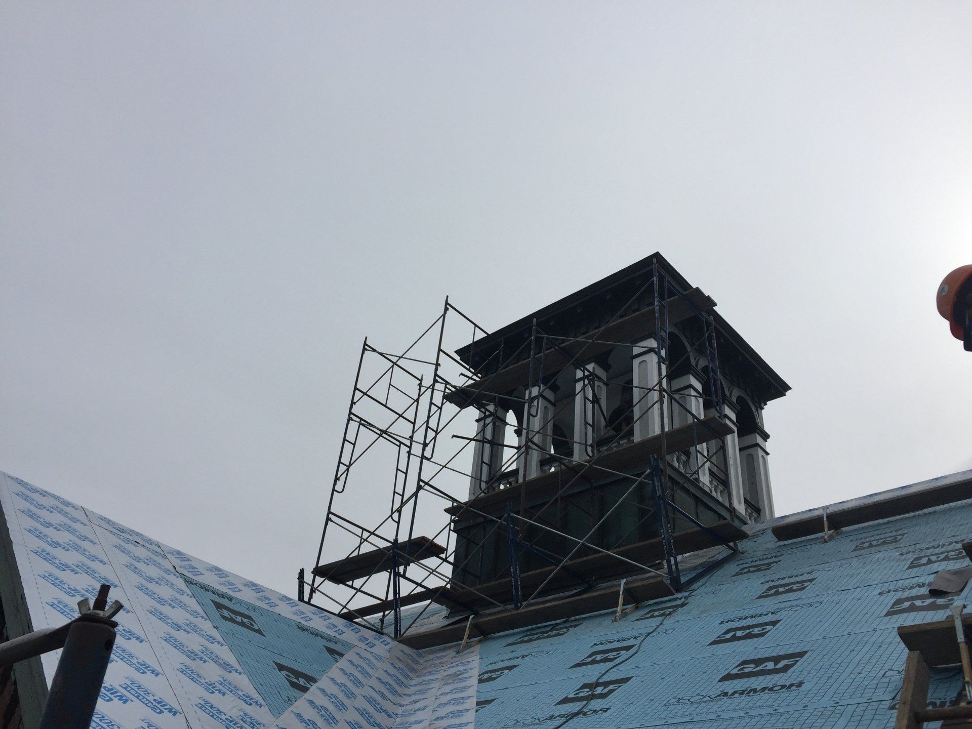 A chimney is being installed on the roof of a building