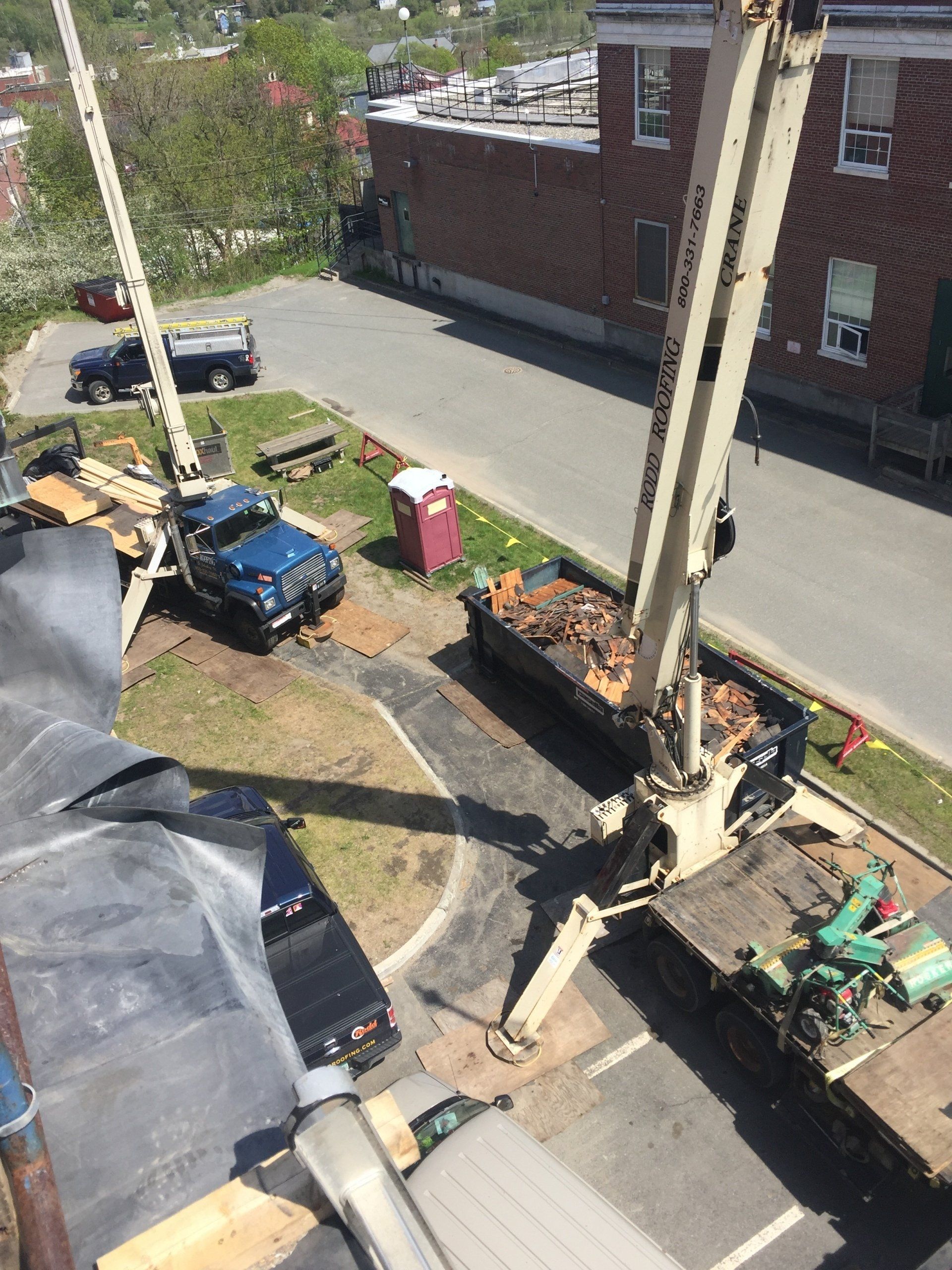 Rodd Roofing preparing a commercial roof  for a slate roof using their crane trucks