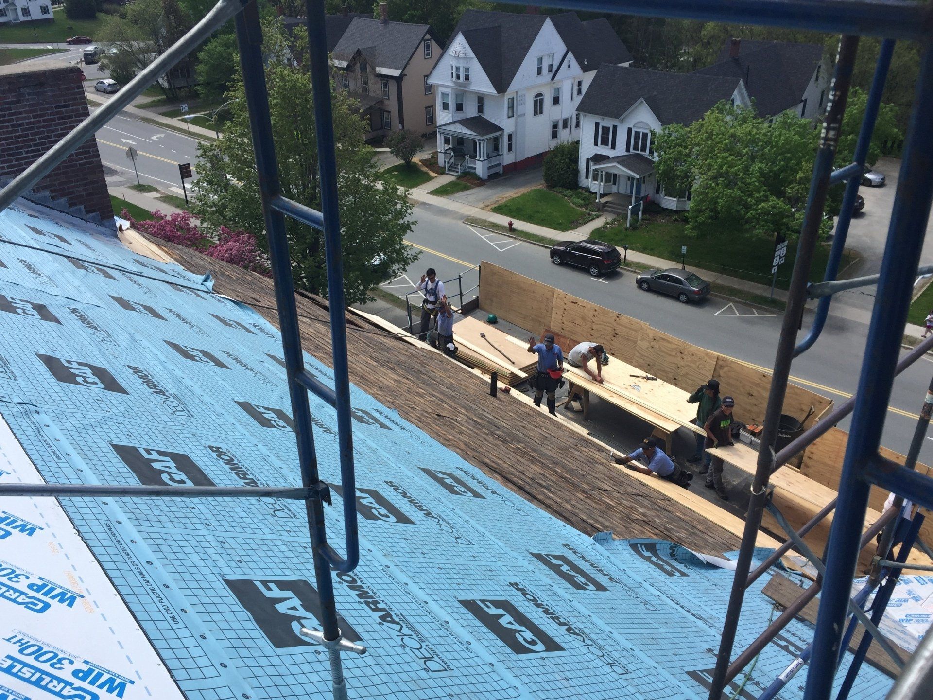 Rodd Roofing  preparing a commercial for a slate roof using their crane trucks