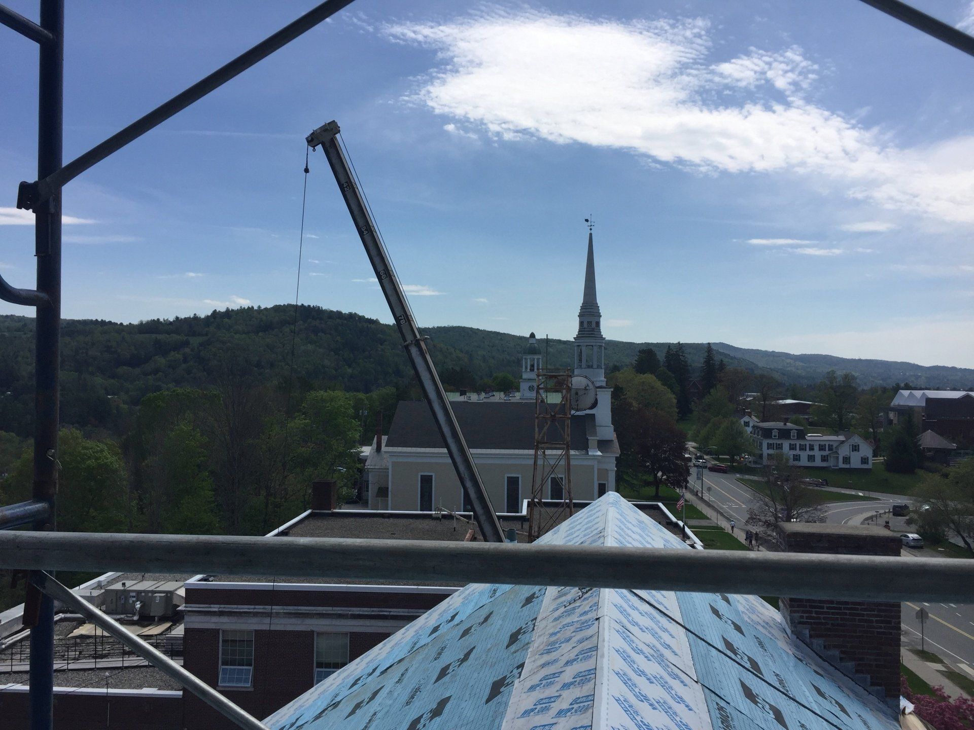 A view of a church from the top of a building.